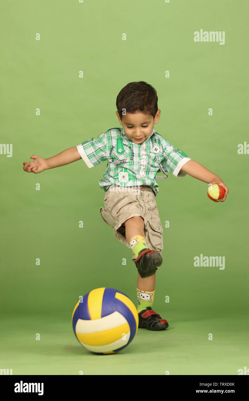 Boy playing with balls Stock Photo - Alamy