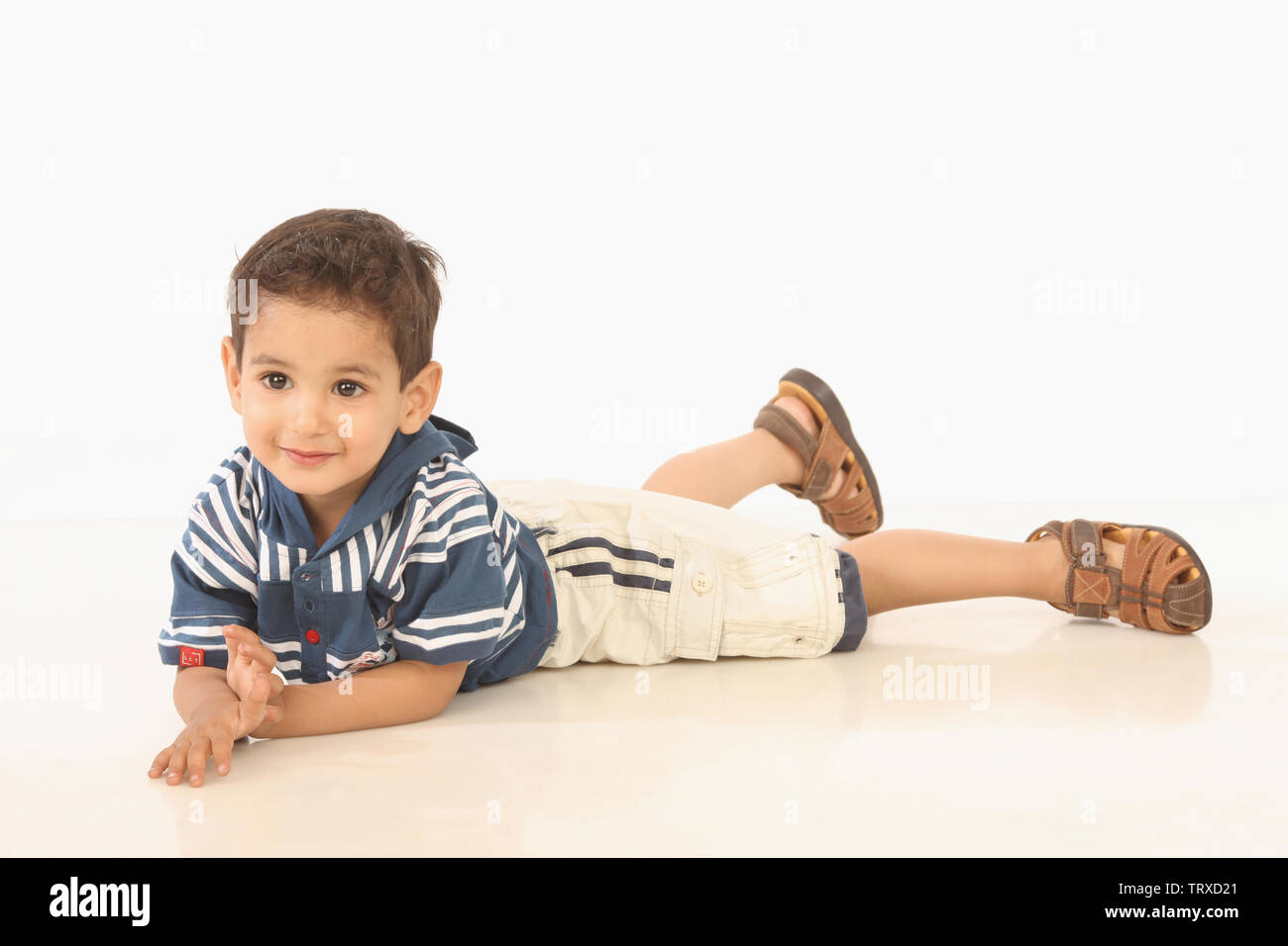 Boy lying down on the floor Stock Photo Alamy