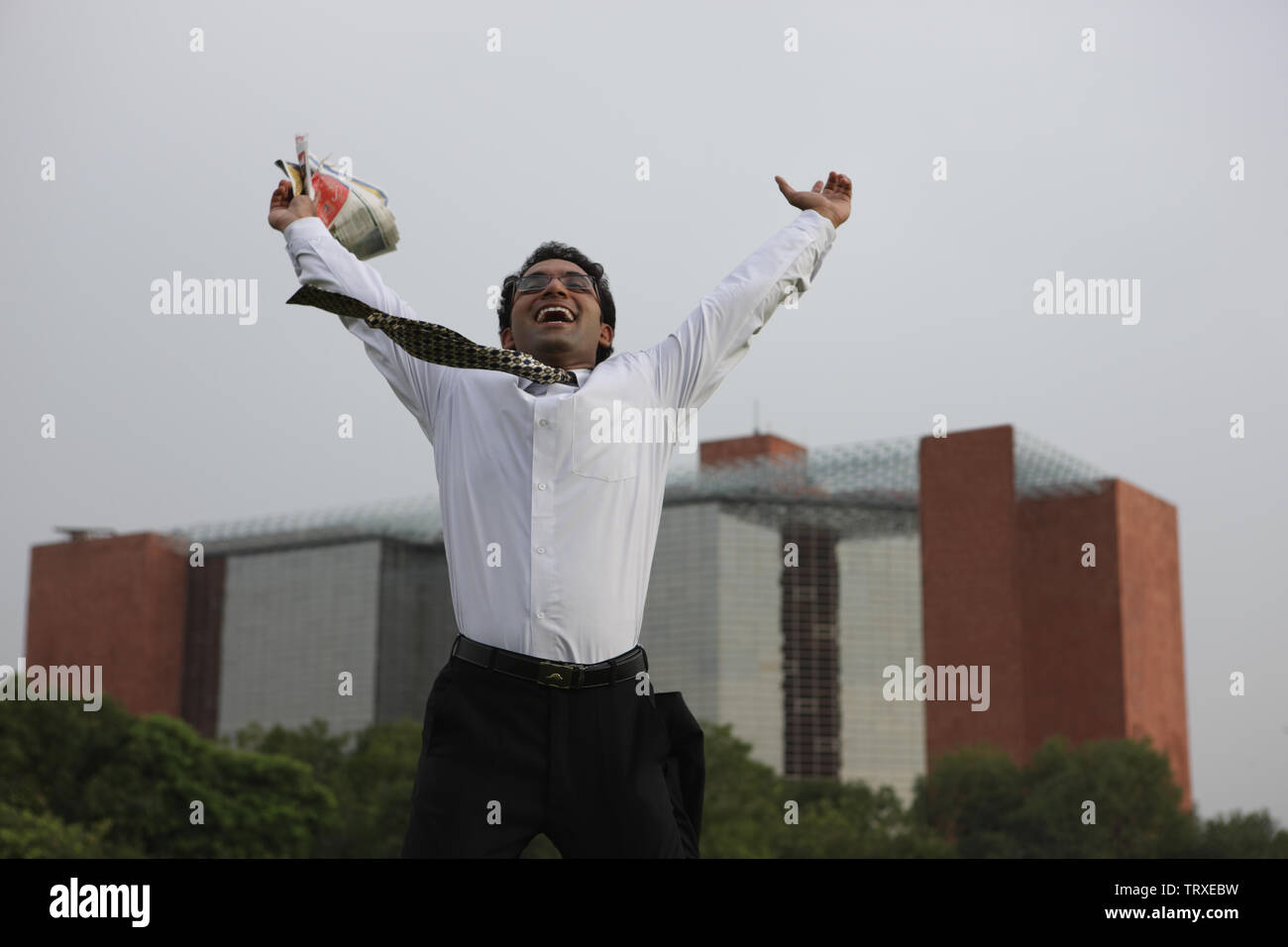 Excited business man jumping into the air Stock Photo