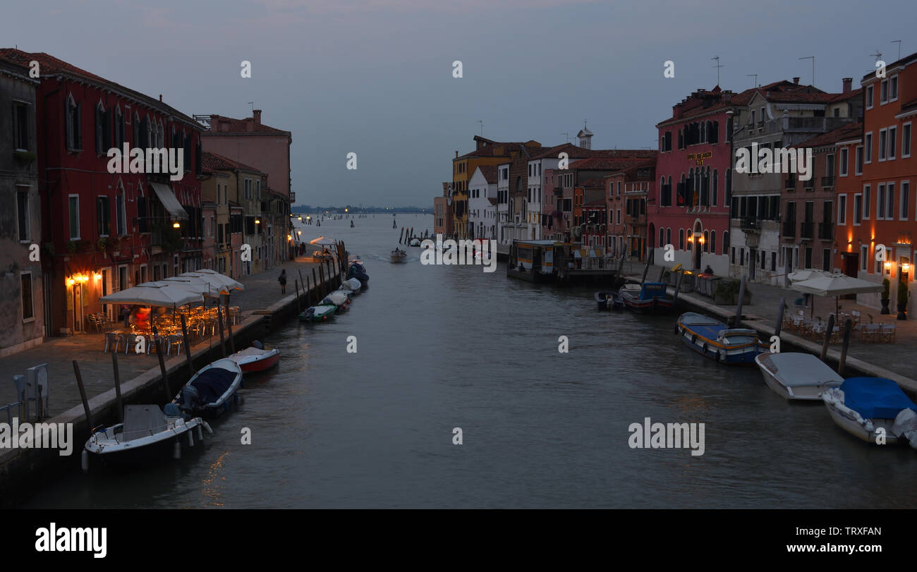 Cannaregio Canal  early  evening with  illuminated restaurants and bars Venice. Stock Photo
