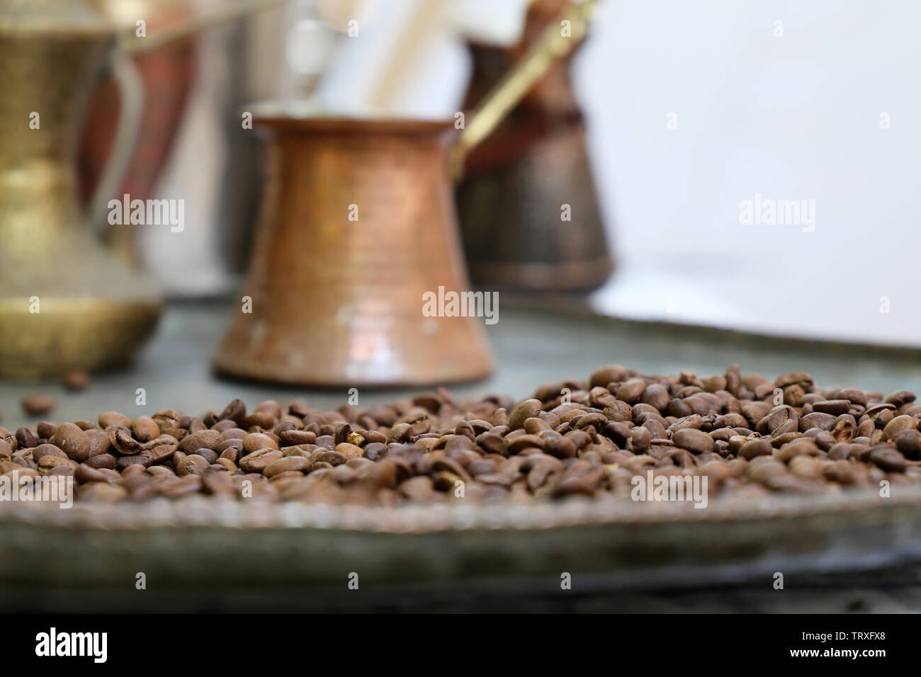 Coffee beans on a copper plate and old turkish coffee pot. Old cafe in Istanbul Stock Photo