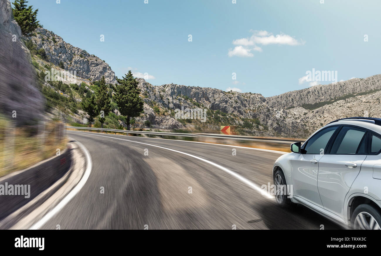 White car rushing along a high-speed highway Stock Photo - Alamy