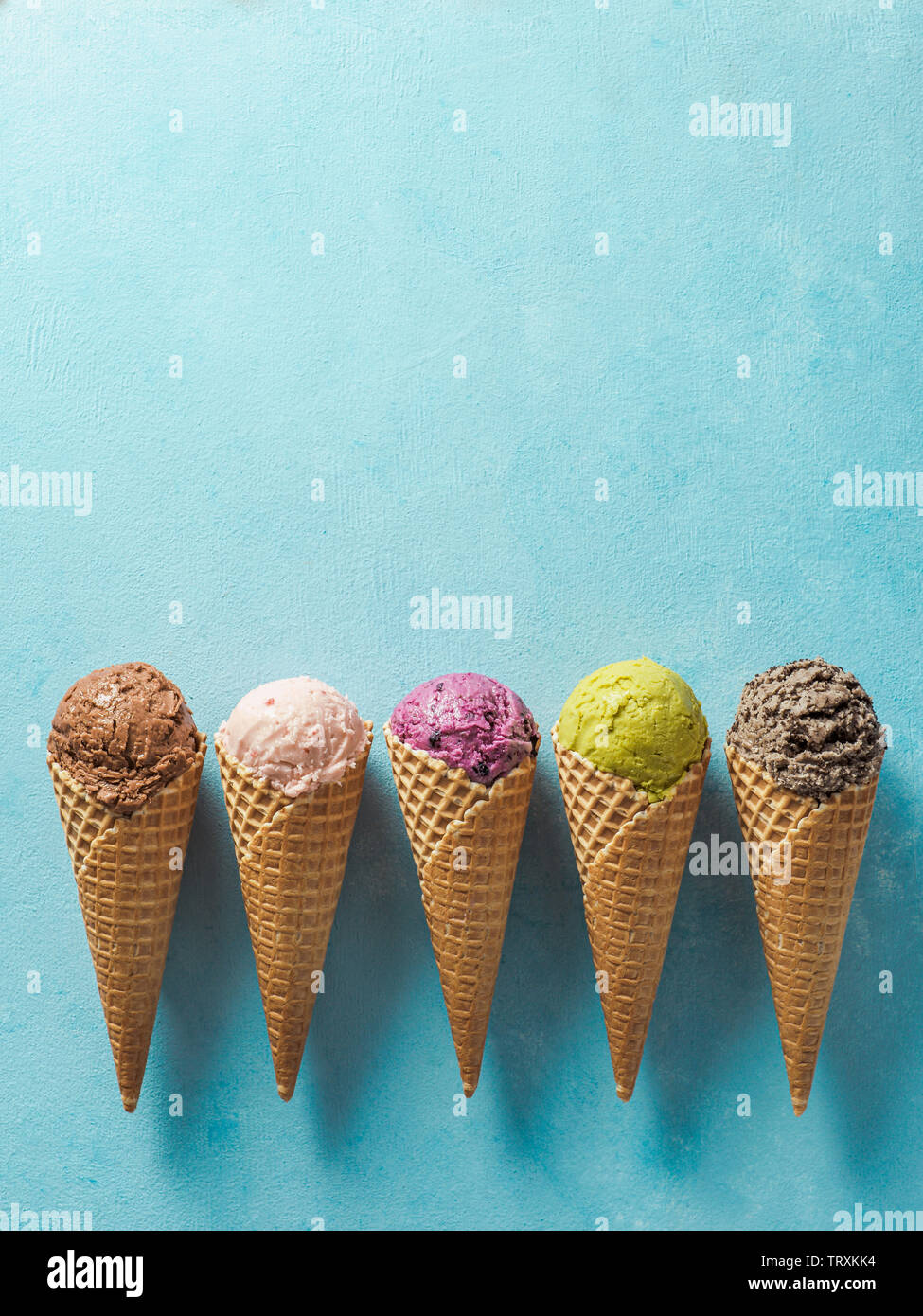 Various ice cream scoops in cones with copy space. Colorful ice cream