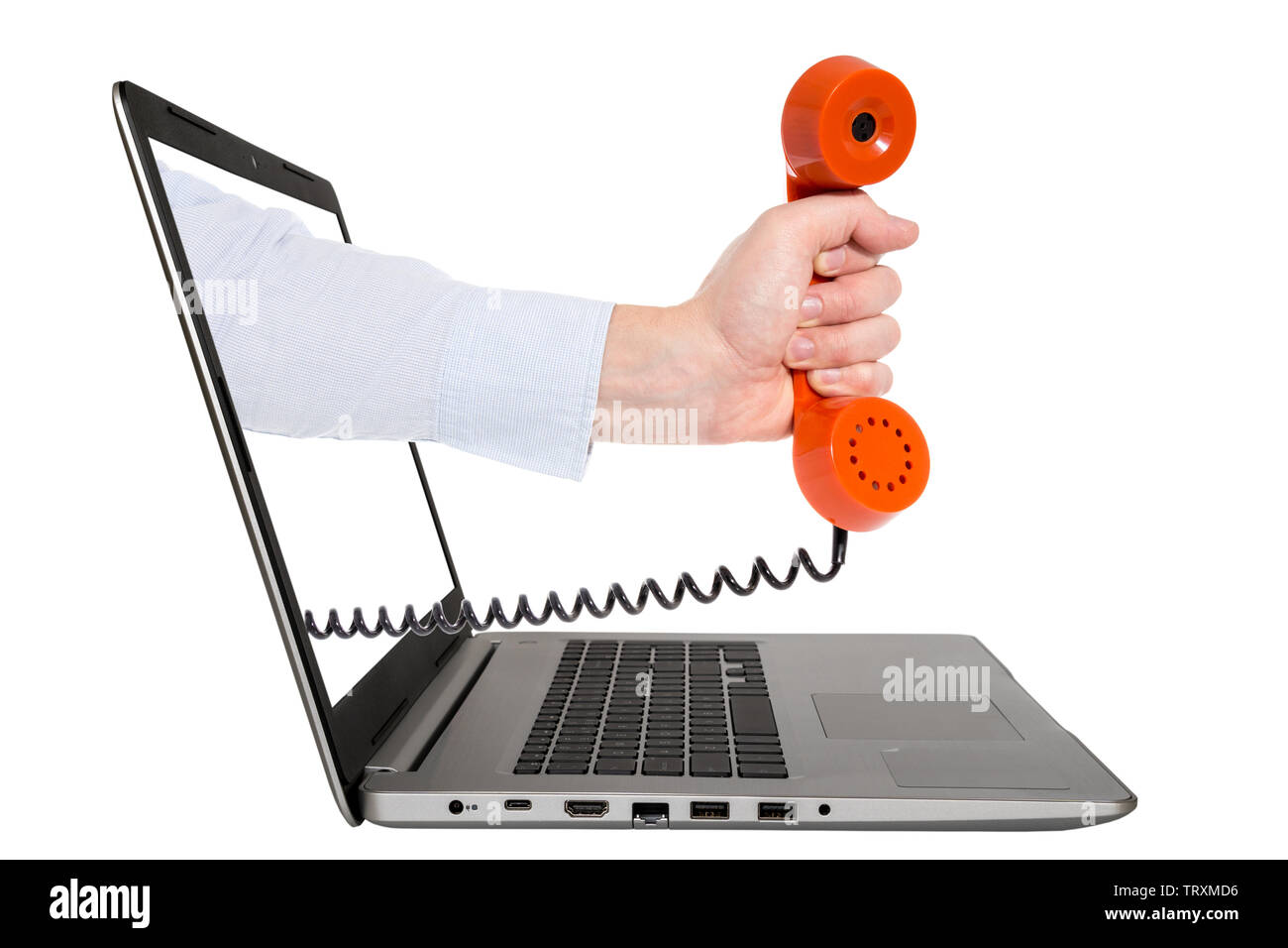 Hand with vintage phone coming out of a laptop. Isolated on white