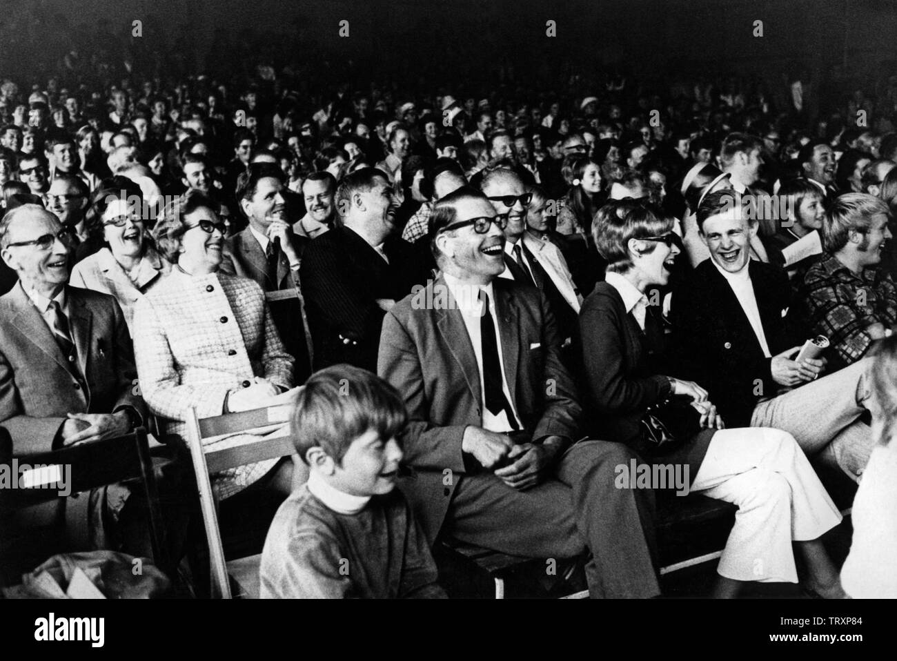 Audience in the 1960s. They are all laughing at something or someone on the stage. Sweden 1960s Stock Photo
