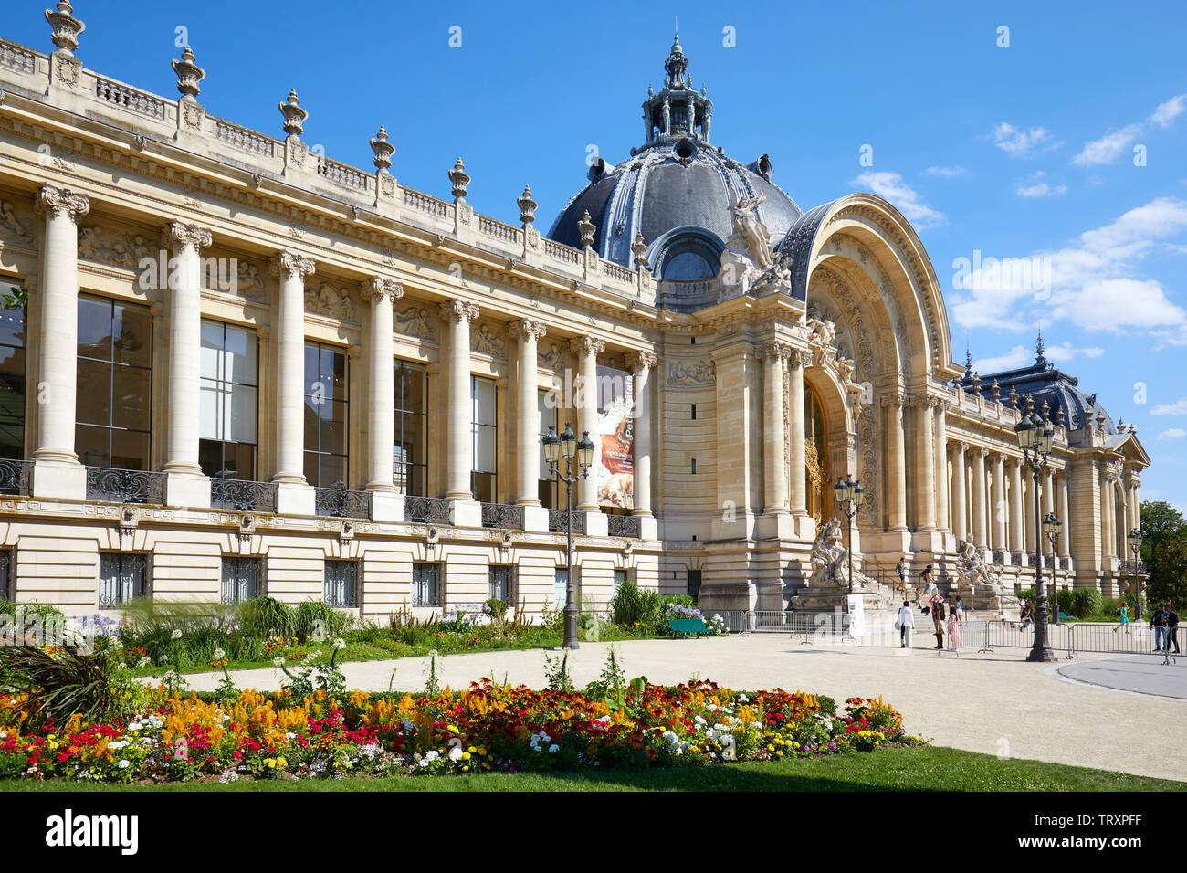 PARIS, FRANCE - JULY 21, 2017: Petit Palais building and colorful flowerbed in a sunny summer day, clear blue sky in Paris, France. Stock Photo