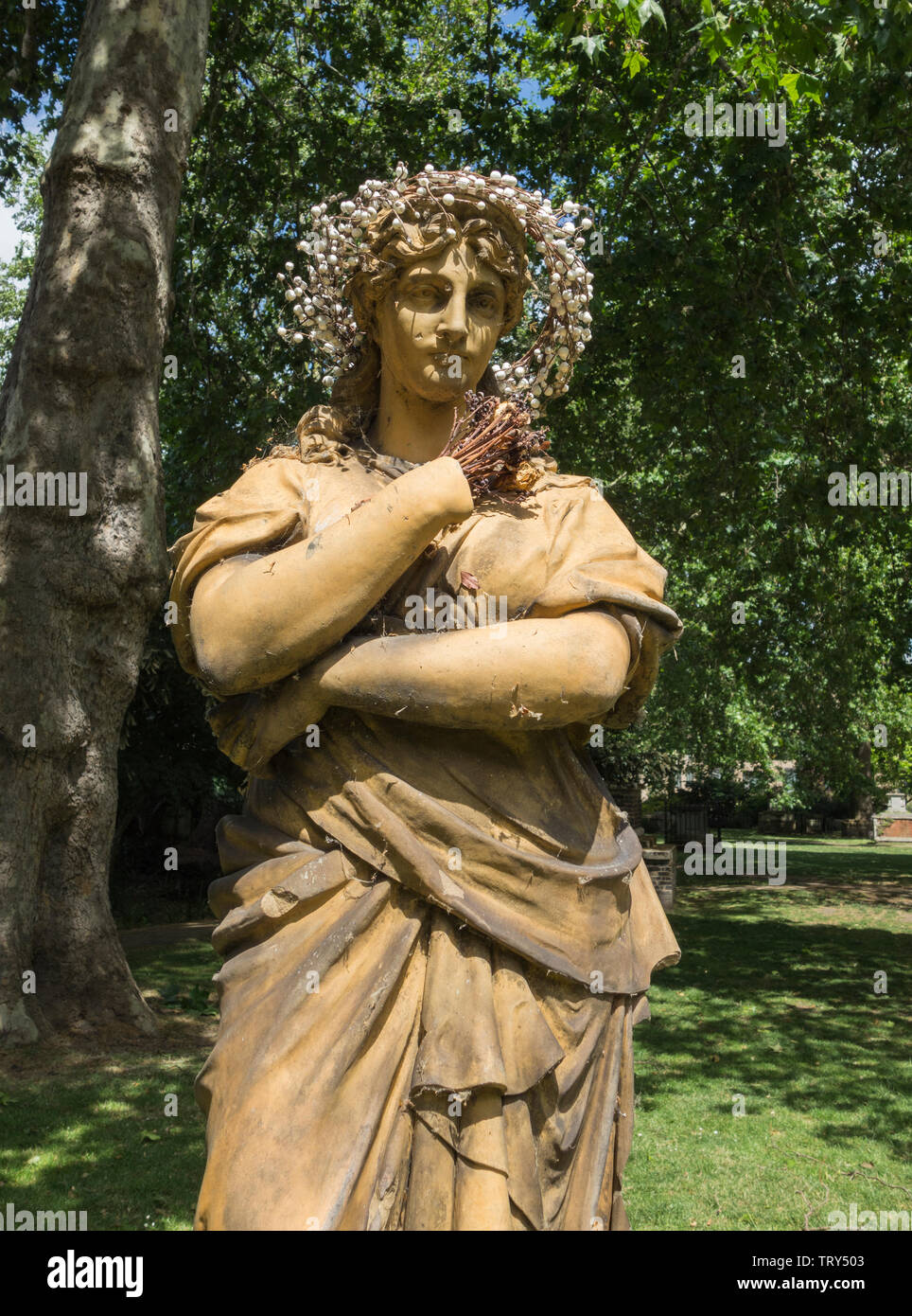 Terracotta statue of Euterpe the Muse of instrumental music, in St George's Garden's, Camden, London, UK Stock Photo