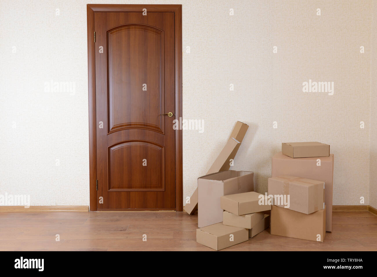 Empty Room With Stack Of Cartons Moving House Concept Stock Photo