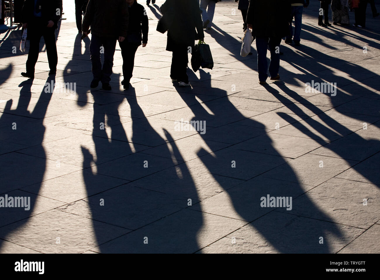 The long shadows of shoppers in a high street in Newcastle upon Tyne, England Stock Photo