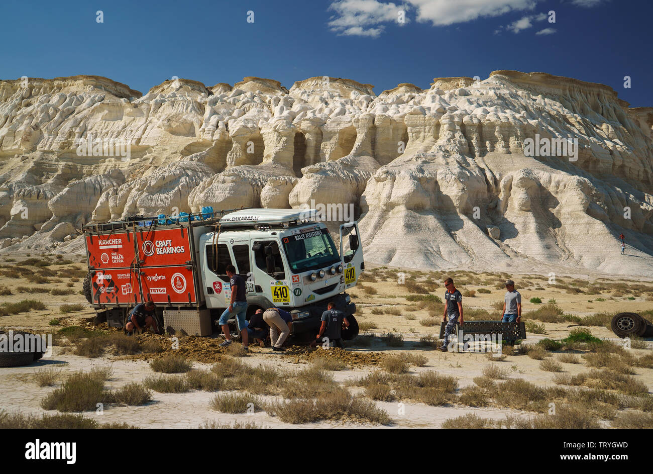 International rally-raid 'Rally Kazakhstan 2017'. Machine technical support one of the commands stuck in the salt marsh. Stock Photo