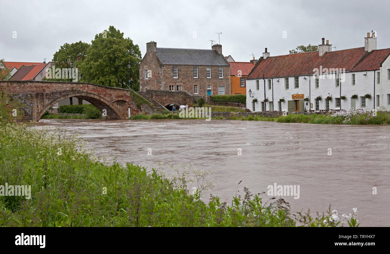 Haddington, East Lothian, Scotland. 13th June 2019. UK weather. Haddington, East Lothian, Scotland. After torrential overnight rain sandbags have been placed to shore up swollen riverbanks after East Lothian saw up to 90mm of rain fall over 24 hours. At the Waterside Bistro, the wall between it and the rising water was given sandbag support. Around Haddington up to 300 sandbags were used to shore up the River Tyne, which has a number of restaurants and businesses nearby. Road services are monitoring the ongoing floods in case the roads need to be closed. Stock Photo