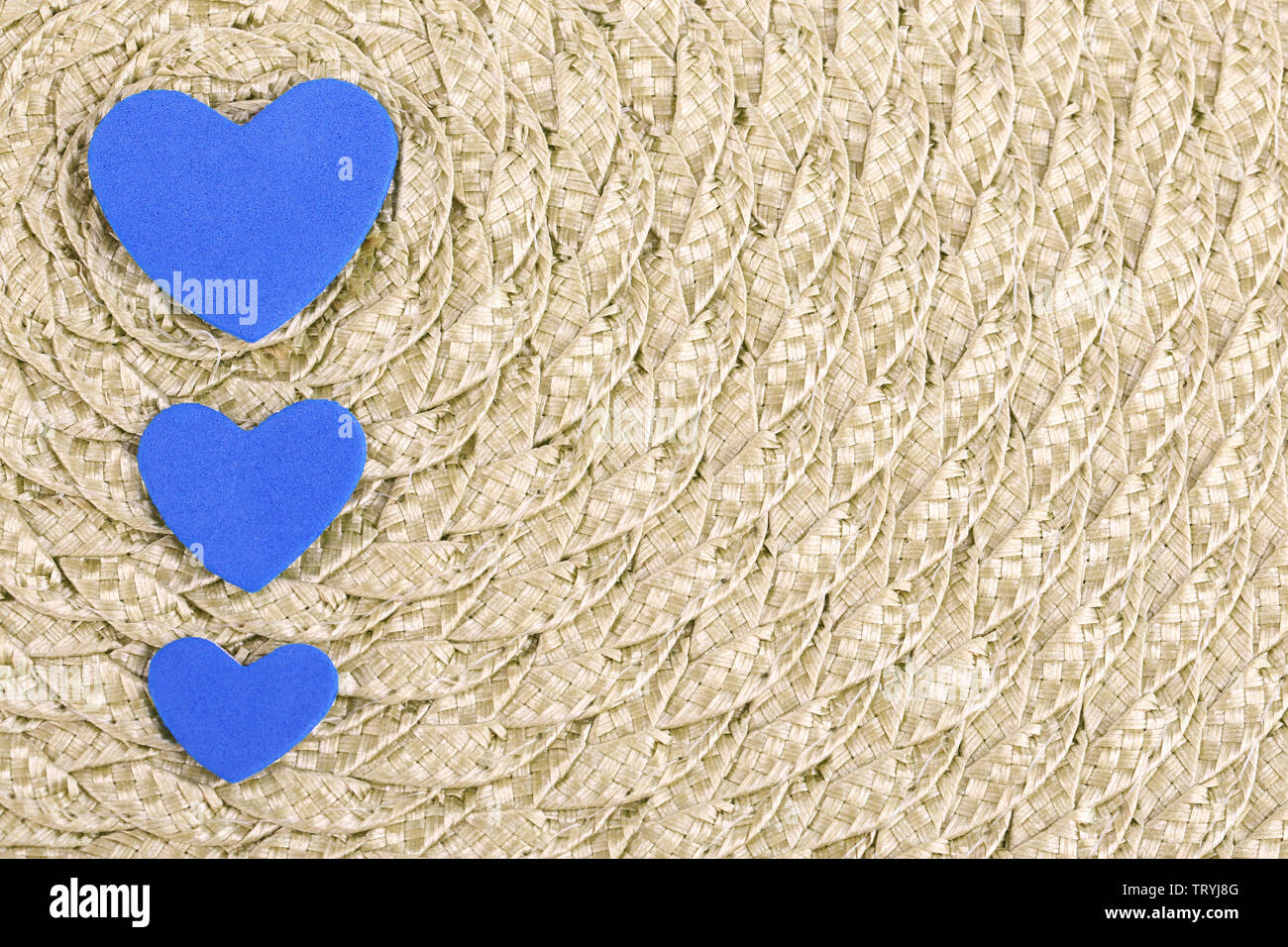Hearts made of felt on green background Stock Photo - Alamy