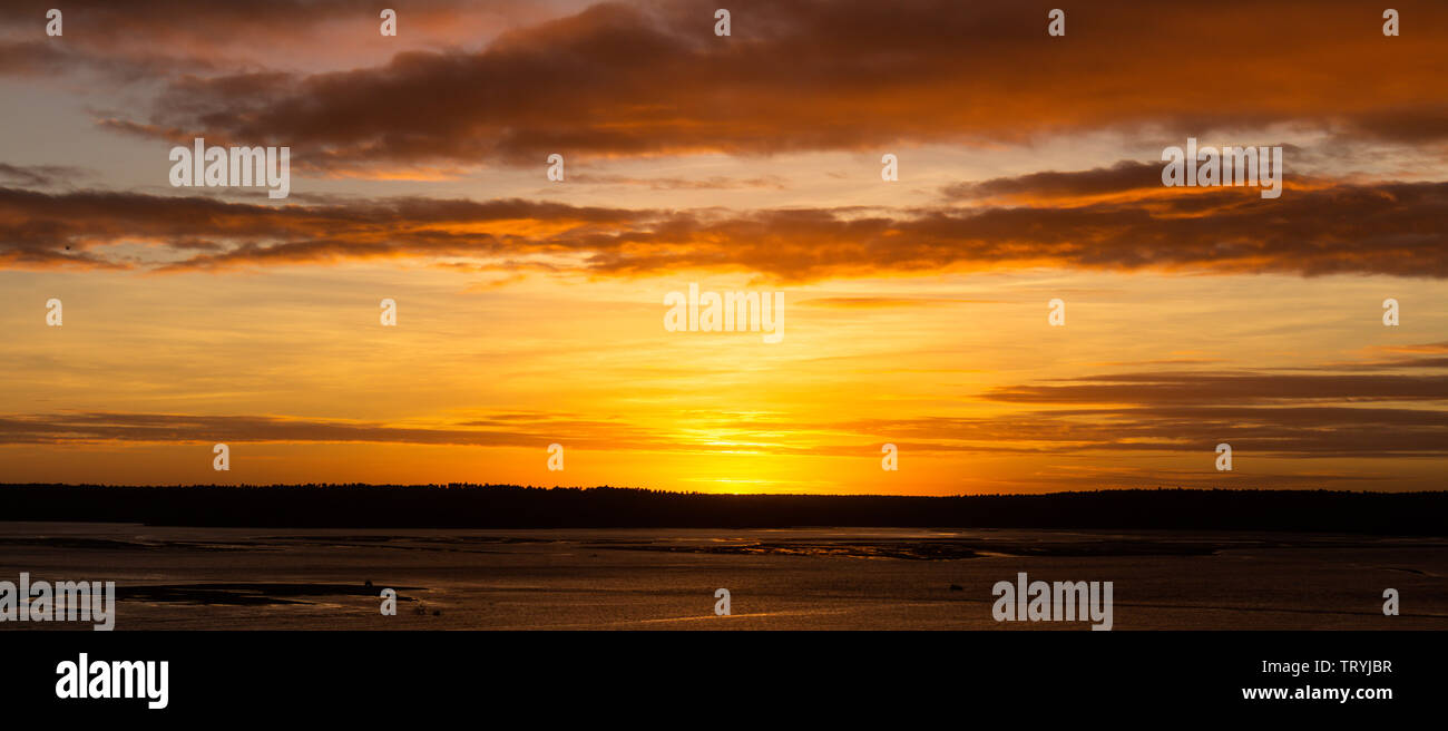 Tranquil sunset over the lake. The whole scene covered in golden colors. Water calm. Concept of tranquility. Vacation landscape. Stock Photo