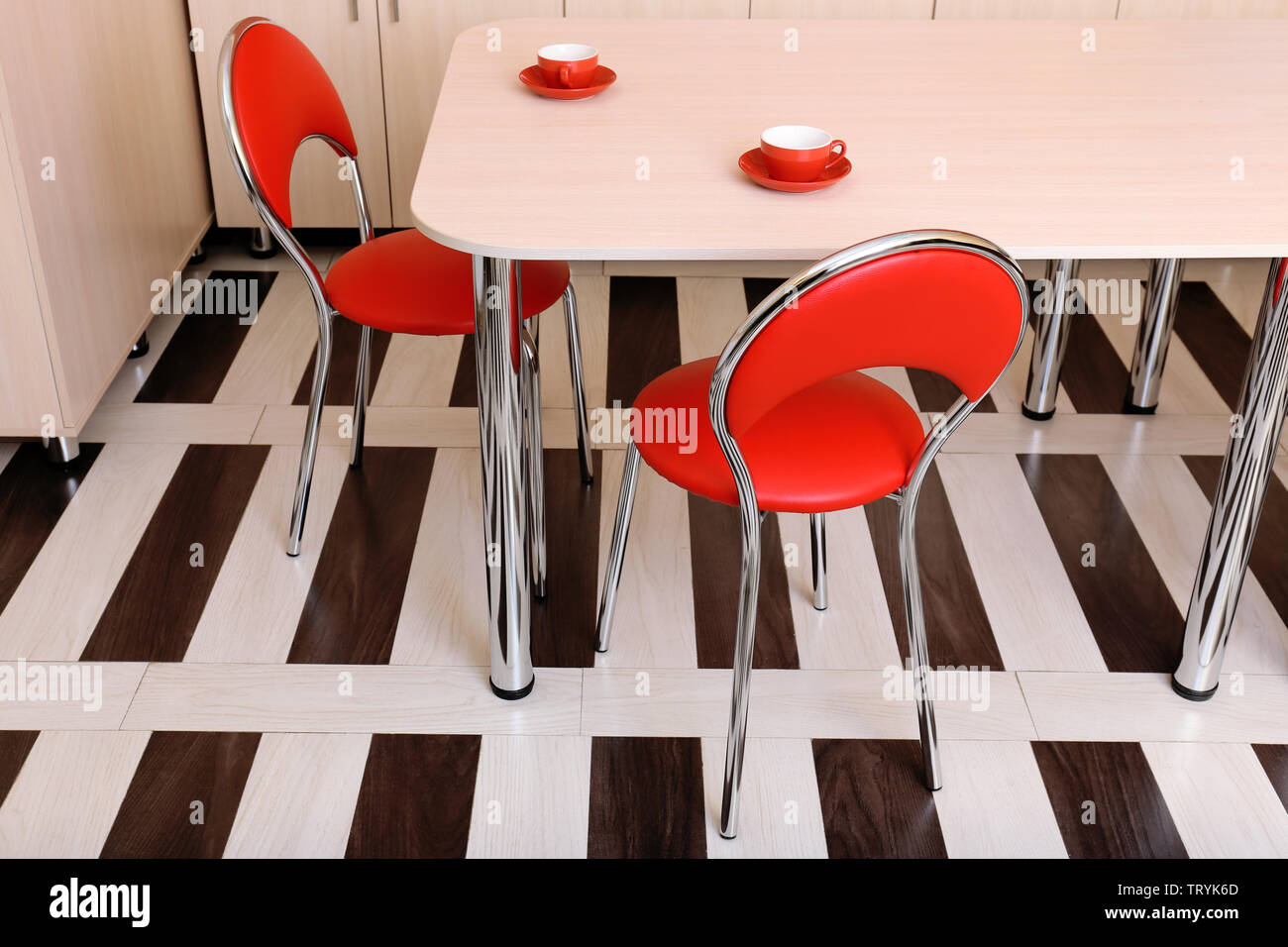 Modern Red Chairs Near Table In Kitchen Stock Photo Alamy