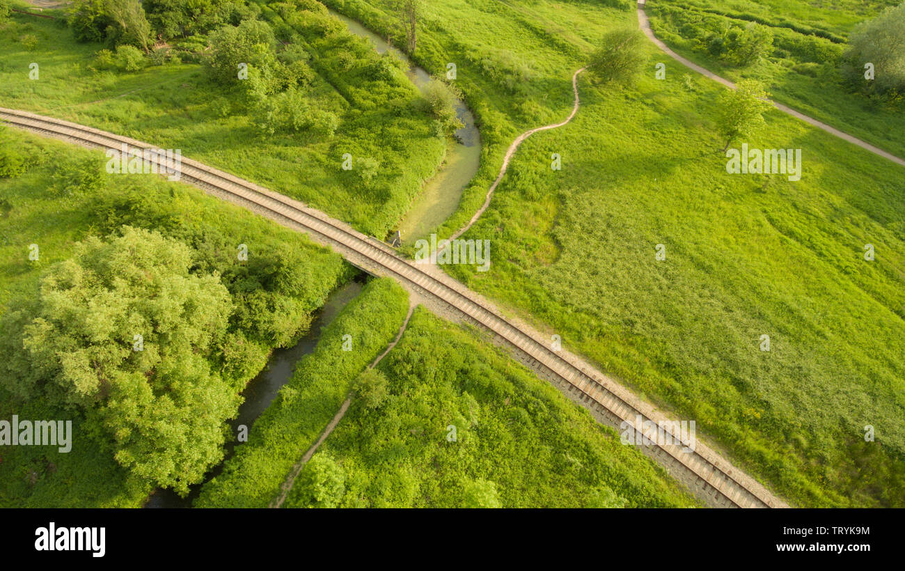 Aerial view of the village railway going across the bridge over boggy
