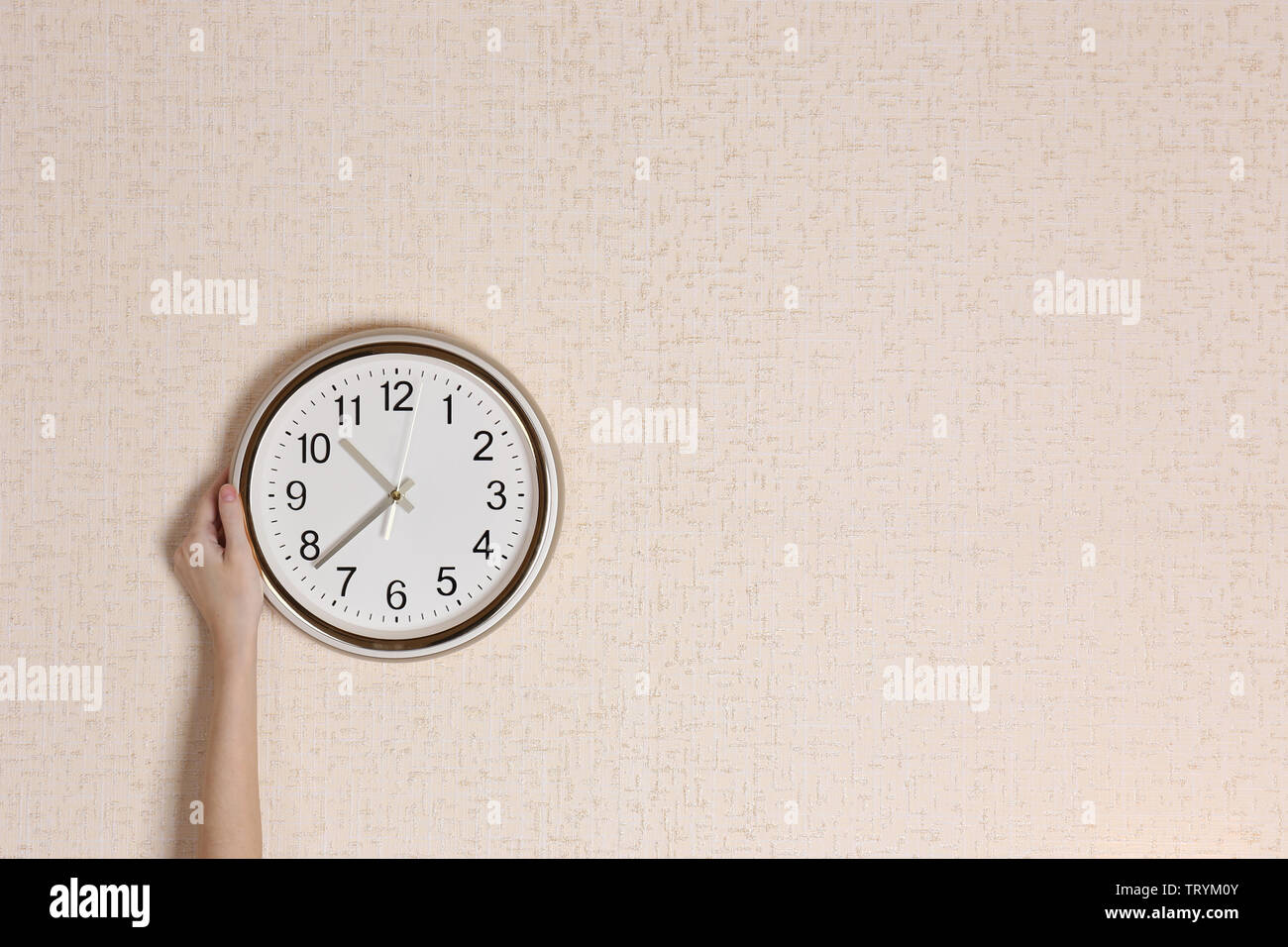 Clock on wall background Stock Photo