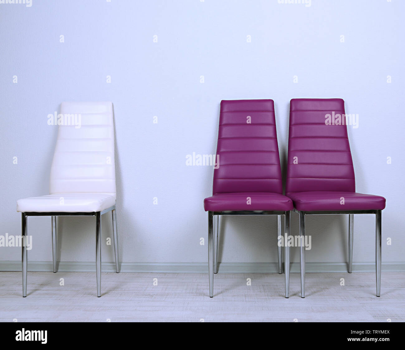 Modern color chairs on wall background Stock Photo Alamy