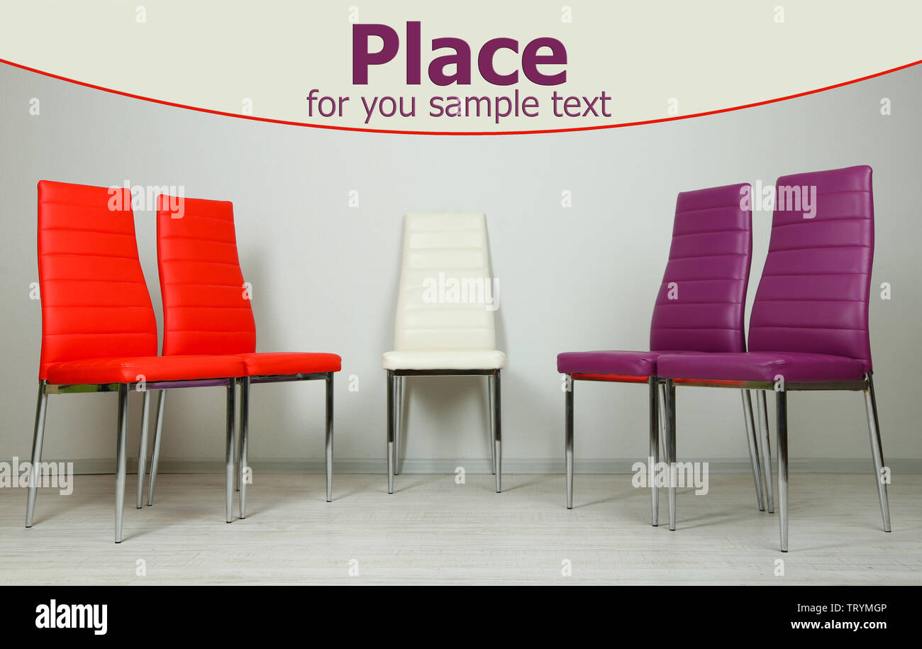 Modern color chairs on wall background Stock Photo Alamy