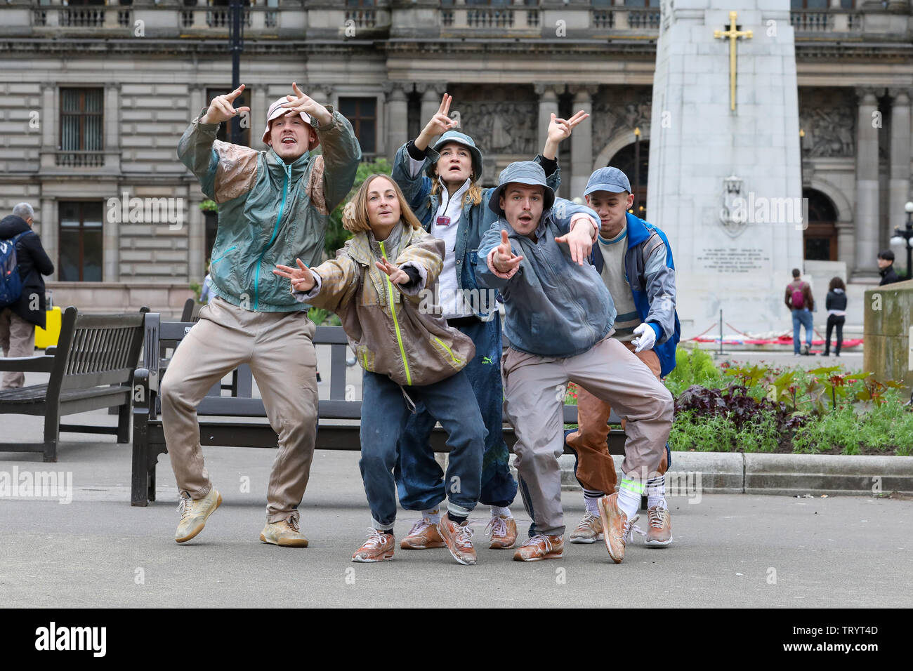 Glasgow, UK. 13 June 2019. Lunchtime crowds in Glasgow's George Square were treated to free dance show by the performers of 'WASTELAND' dance troupe, a high energy theatre marking the 25th anniversary of the demolition of Grimethorpe Colliery in South Yorkshire and 30 years since the rise of the UK rave culture. The Scottish premier is at Glasgow's Tramway theatre on 14th and 15th June. Credit: Findlay/Alamy Live News Stock Photo