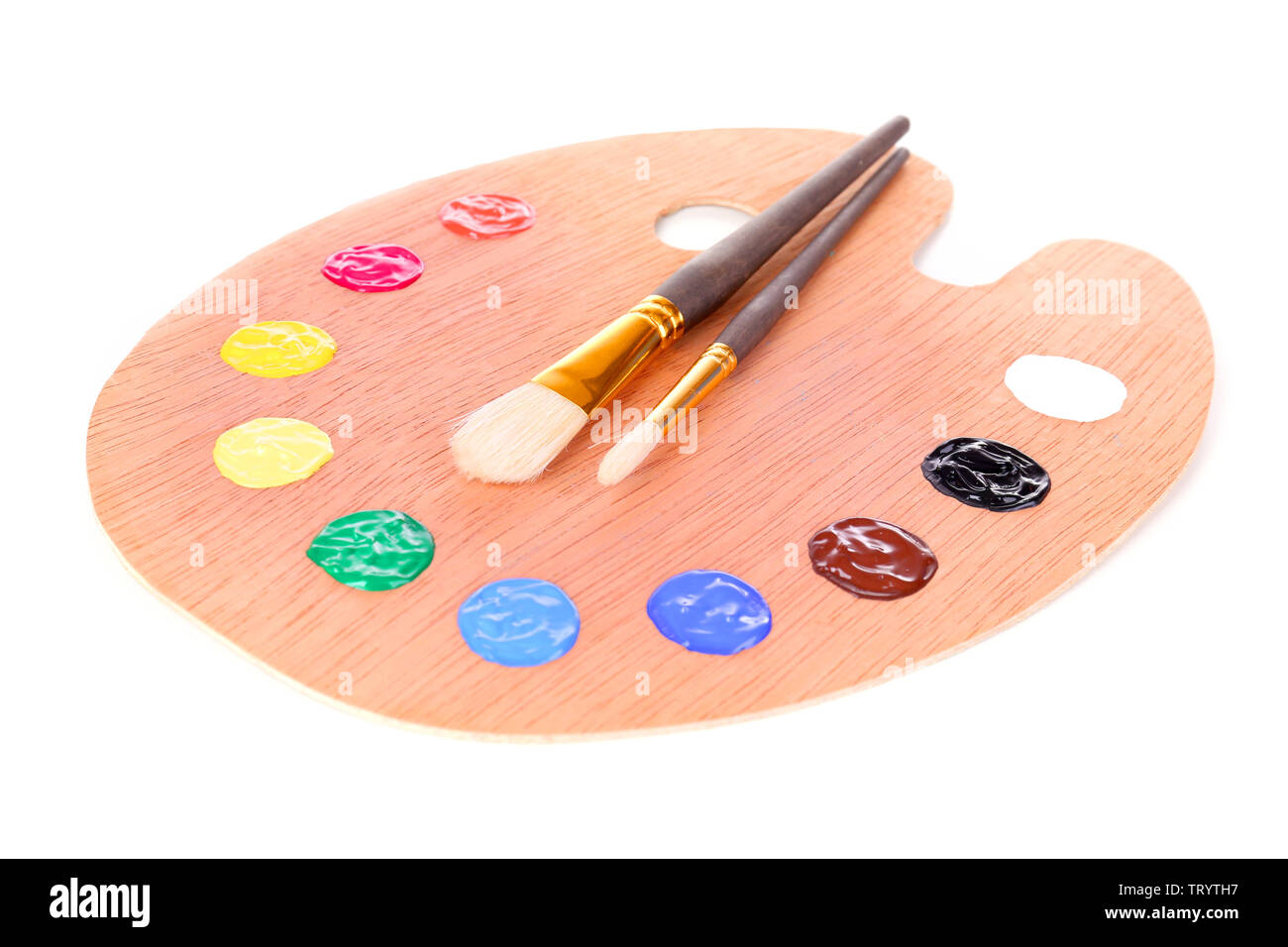 Wooden art palette with paint and brushes isolated on white Stock Photo ...