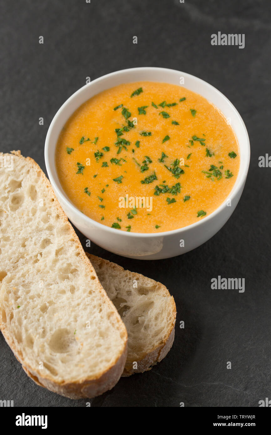 A homemade bowl of lobster bisque, or soup, made from a lobster caught in a pot set in the English Channel. Lobster bisque is made from the shells of Stock Photo