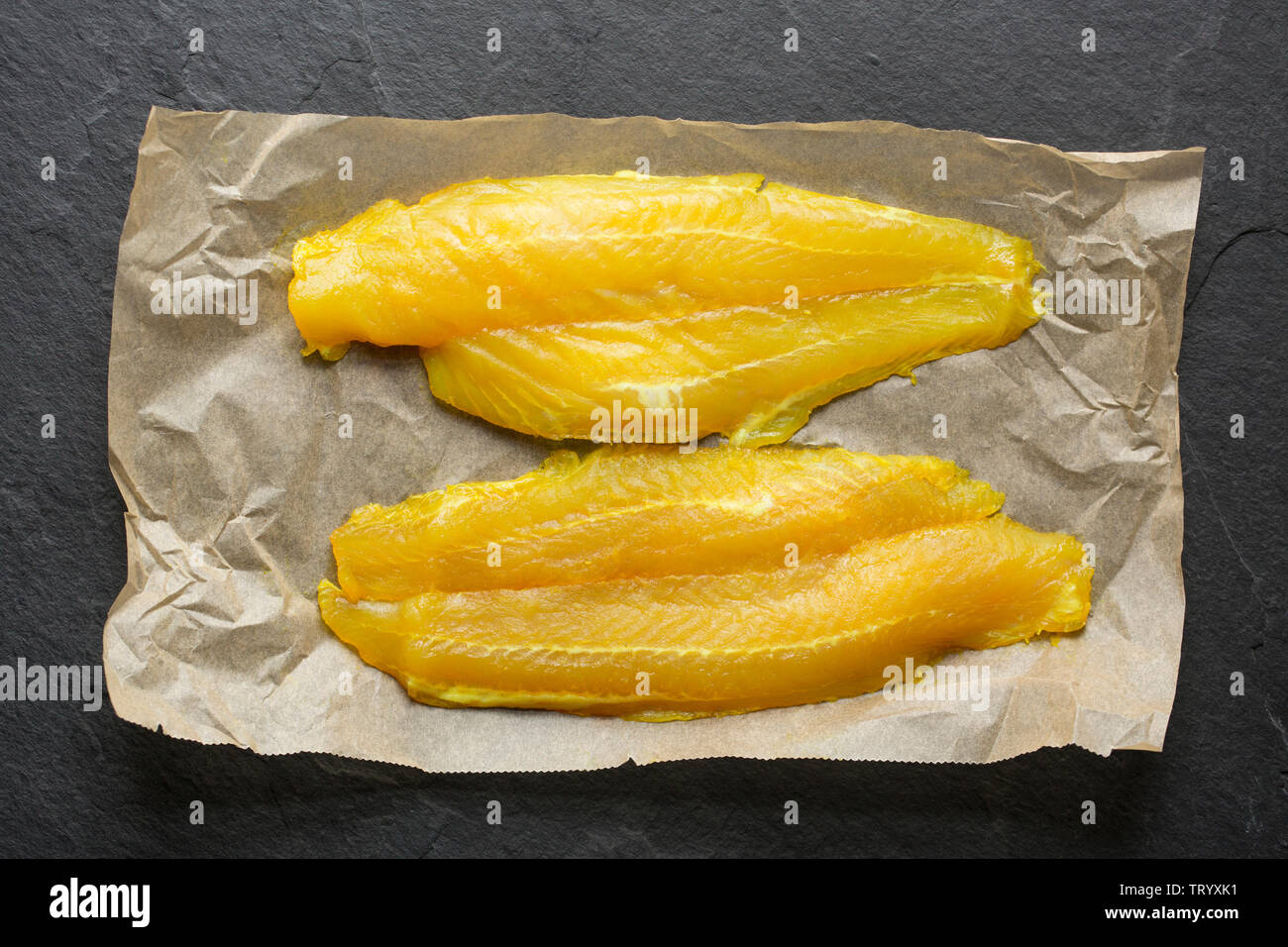 Two smoked, farmed Basa fillets, Pangasius Hypophthalmus, imported from Vietnam and bought in the UK from a Lidl store. Basa, also known as river cobb Stock Photo
