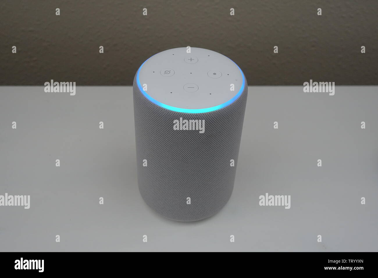 Orlando, FL/USA-5/17/19: An Amazon Alexa Echo, (known as Alexa, is a virtual assistant) sitting on a white background in listening mode. Stock Photo