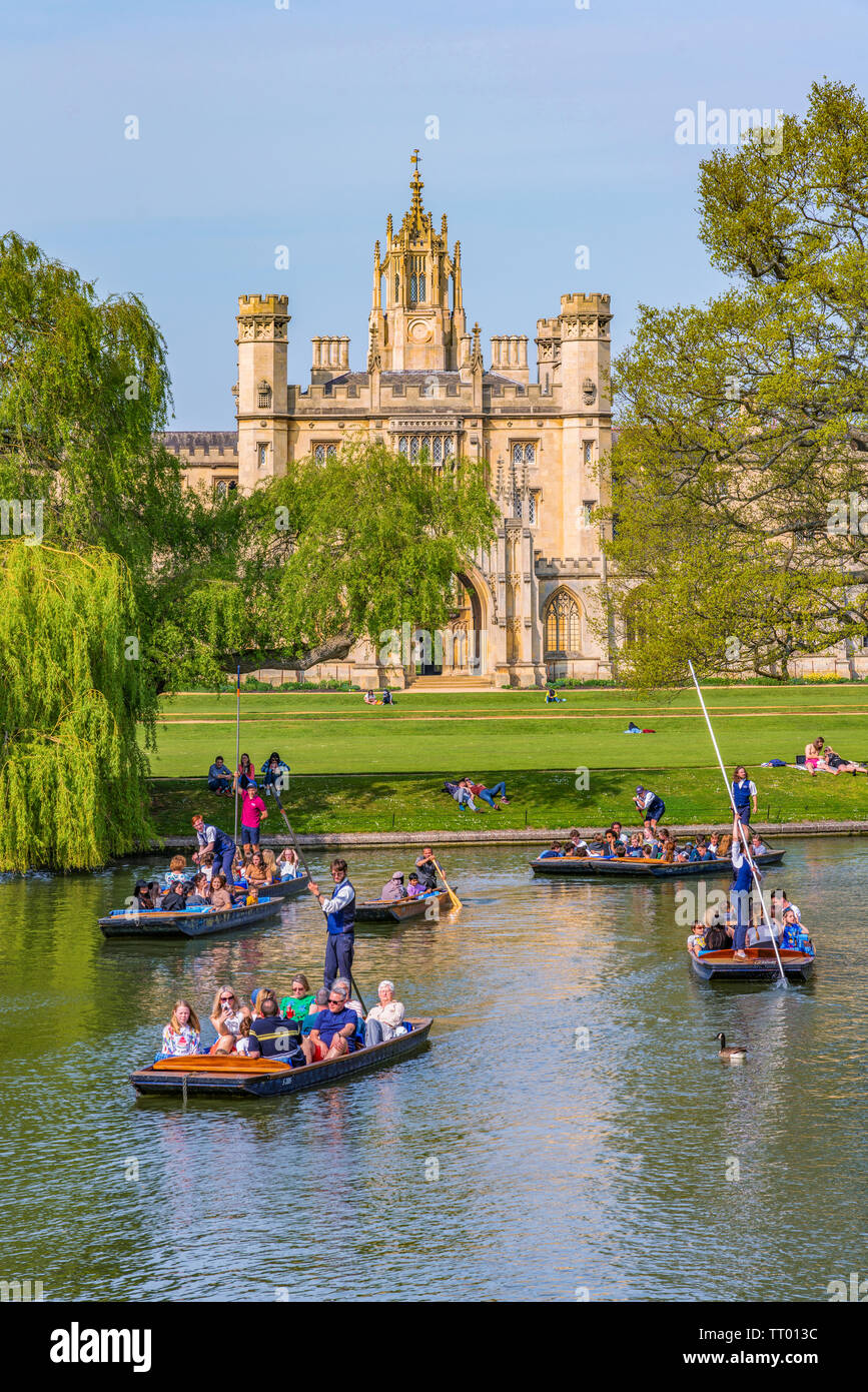 CAMBRIDGE, UNITED KINGDOM - APRIL 18: Scenic view of traditional punt boats along the River Cam with traditional British architecture in the distance Stock Photo