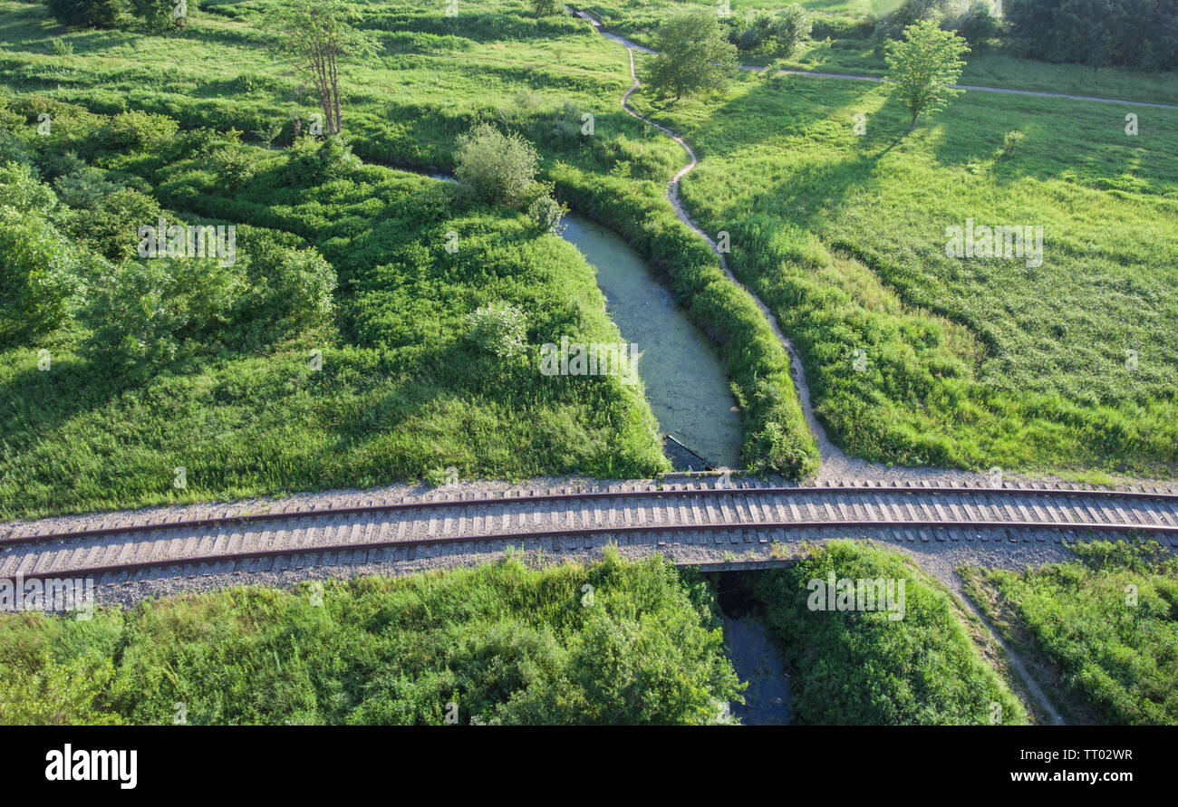 Aerial view of the village railway going across the bridge over boggy
