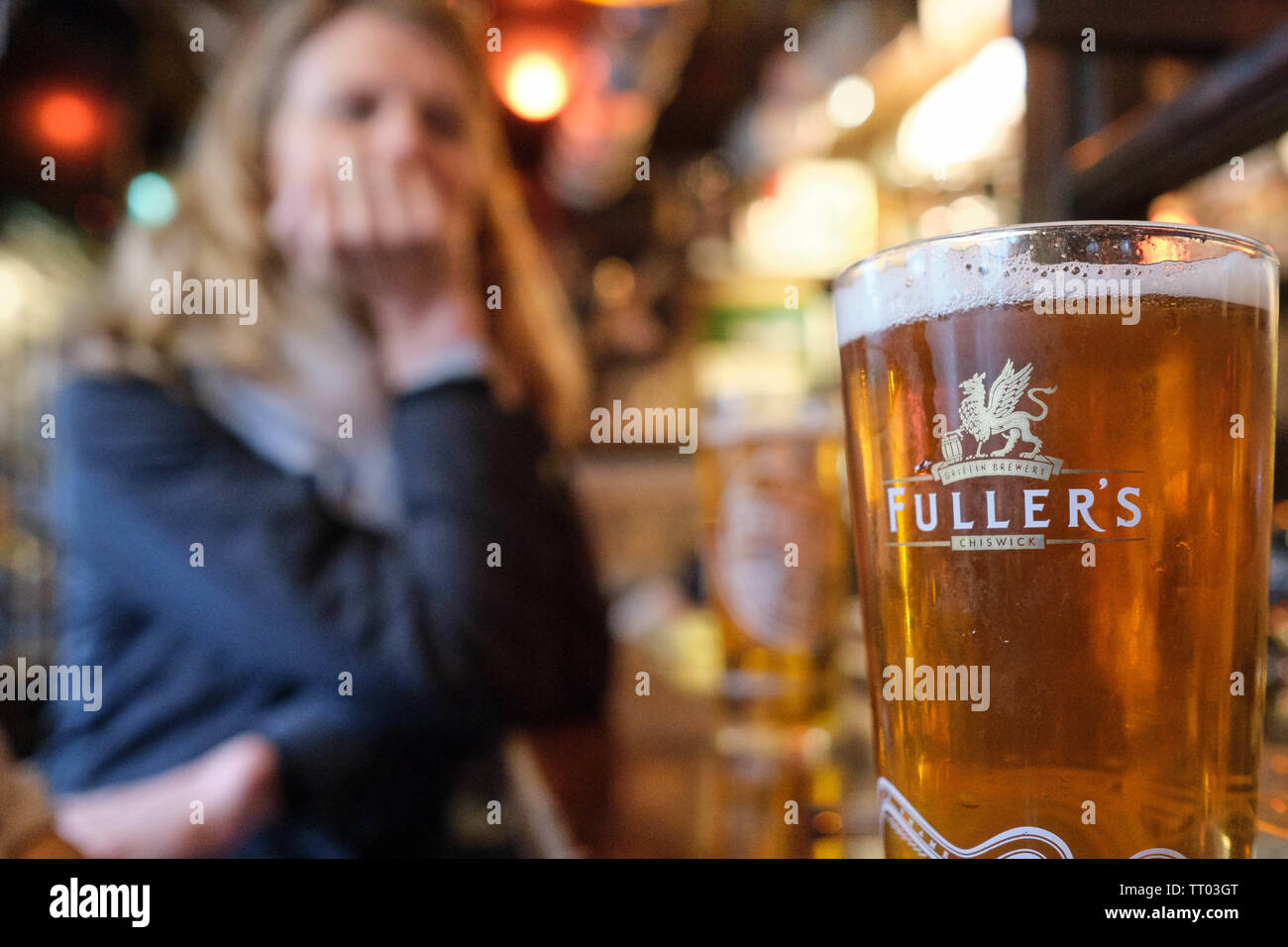 Person enjoying pint of beer at a pub in Kensington, London, UK. (Churchill Arms Pub) Stock Photo