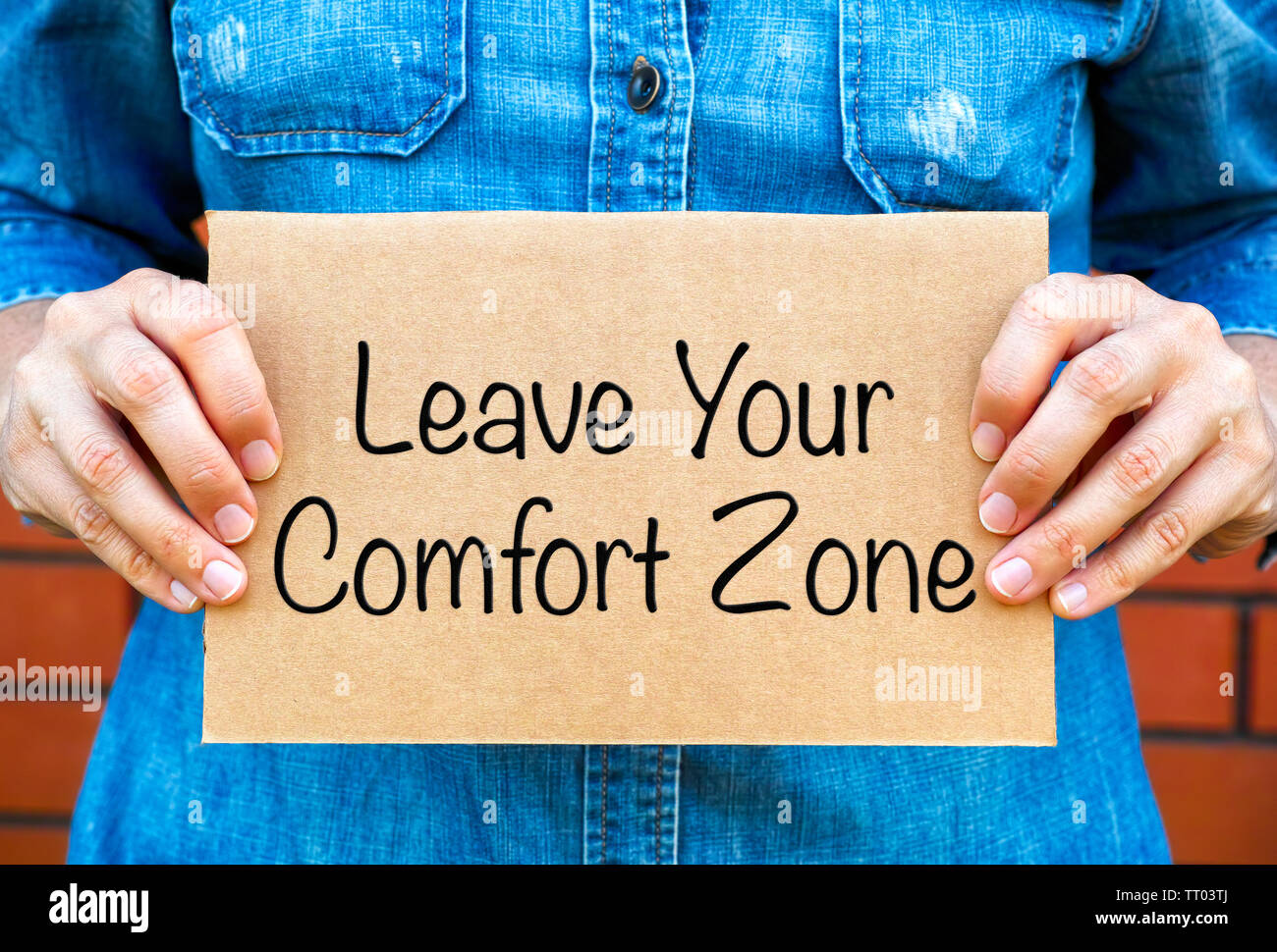 Woman Hands Holding Piece Of Cardboard With Phrase Leave Your