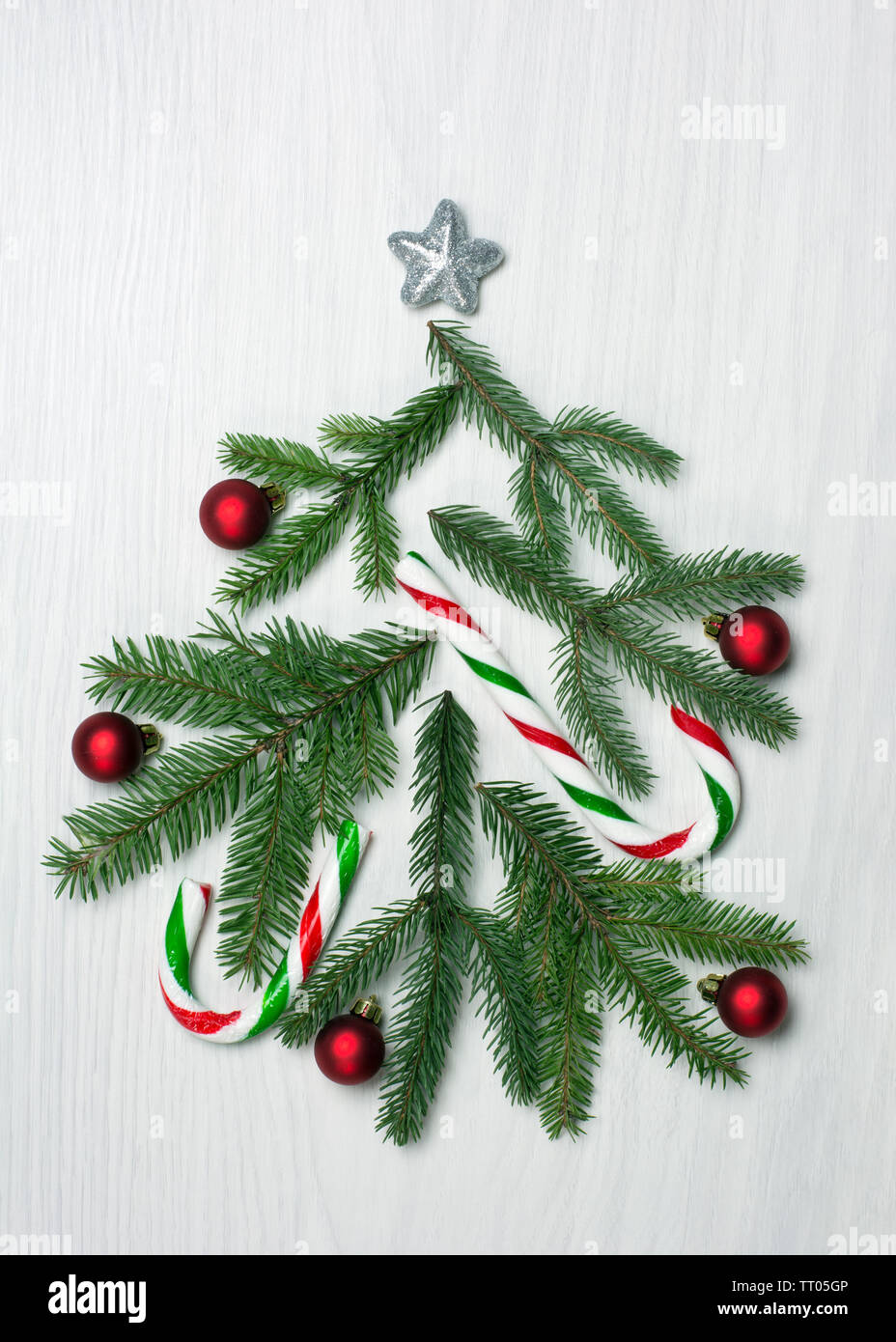 Christmas tree concept with green fir tree branches, red baubles and