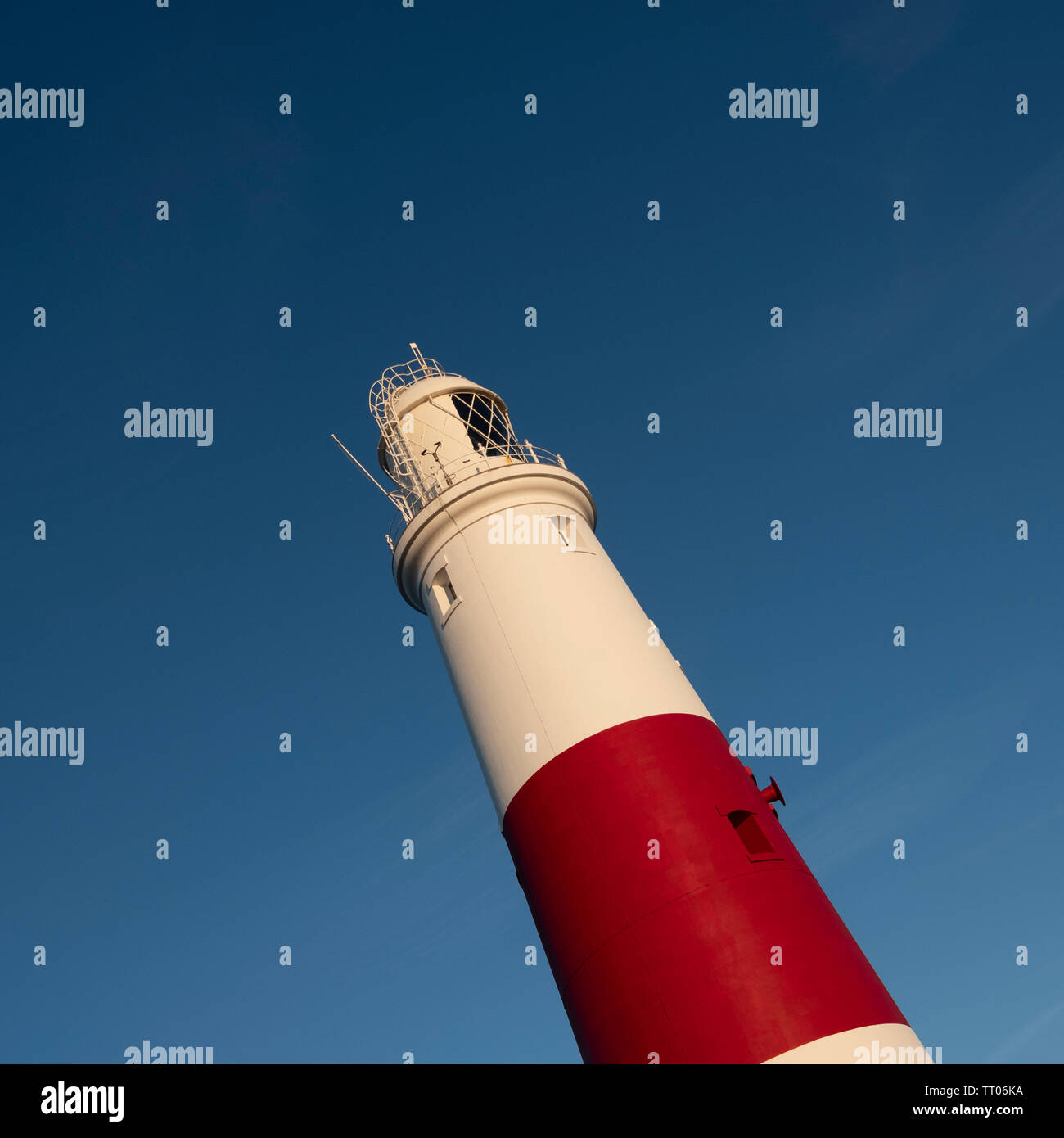 A white and red Portland Bill Lighthouse on a blue sky square background Stock Photo