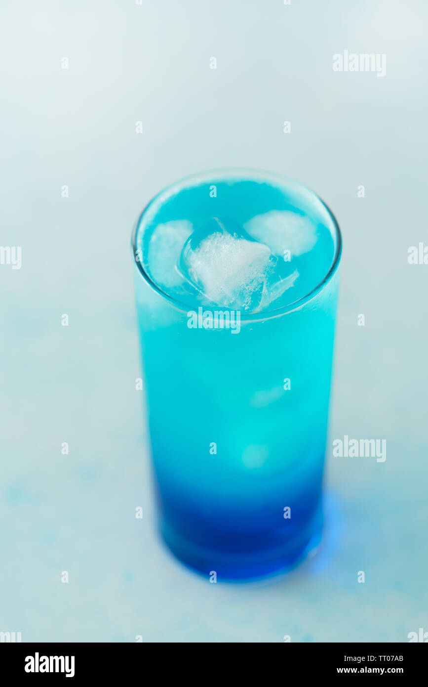 Blue Lagoon Cocktail Is A Collins Glass Light Blue Background