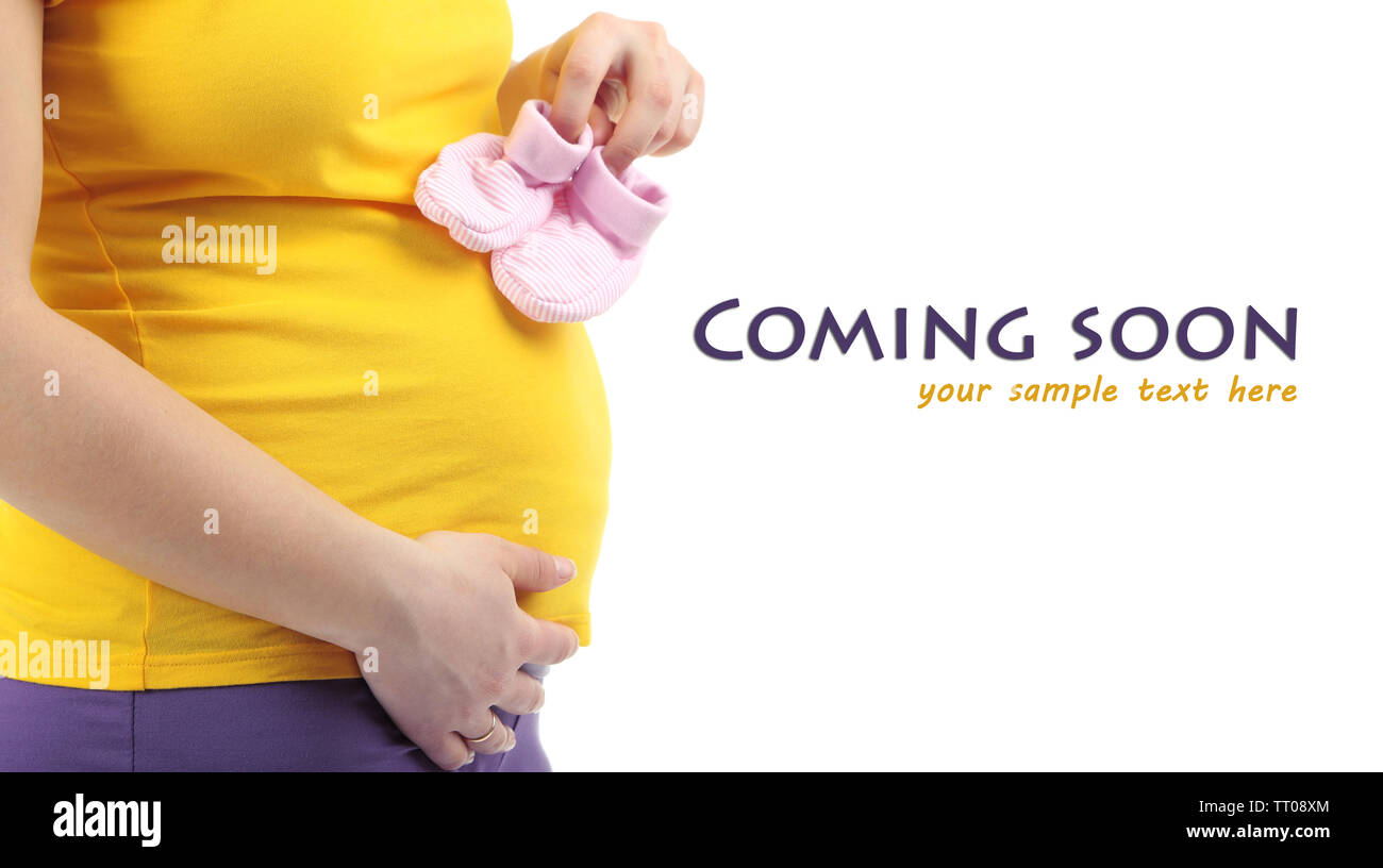 Pregnant woman holding pink baby shoes isolated on white Stock Photo