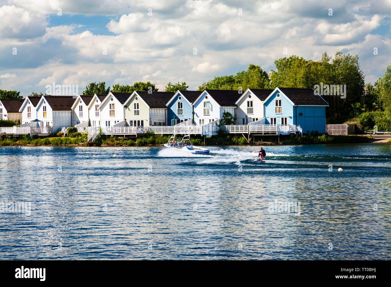 A water skier rides past the luxury holiday homes around Spring Lake in the Cotswold Water Park