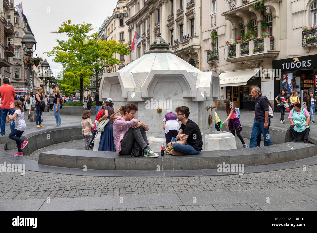 Belgrade, Serbia, June 6th 2019: People resting around drinking fountain at Knez Mihailova Street in the city center pedestrian zone Stock Photo