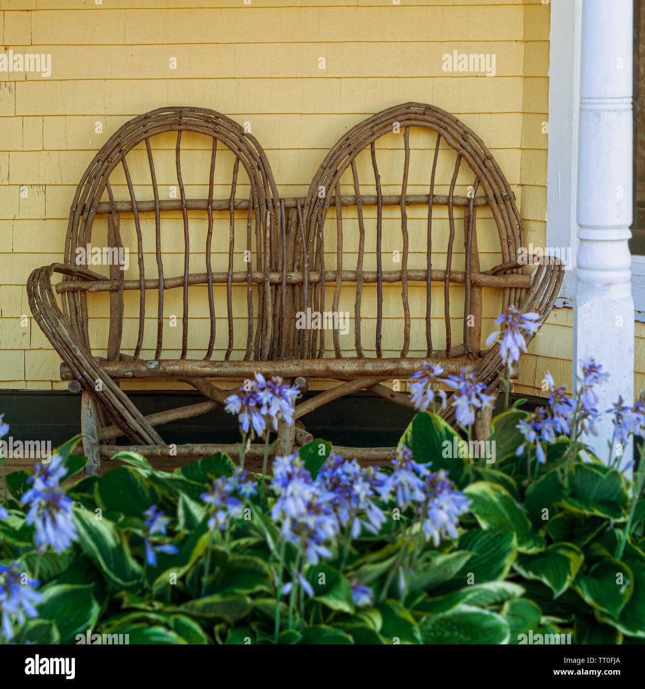 Old fashioned loveseat made of twigs. Stock Photo