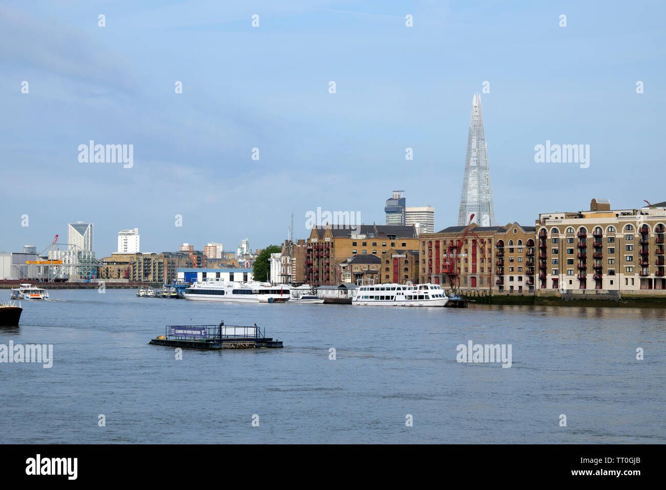 View of Shard skyscraper, Wapping city apartments, boats and barge on the River Thames view from Rotherhithe South London England UK KATHY DEWITT Stock Photo