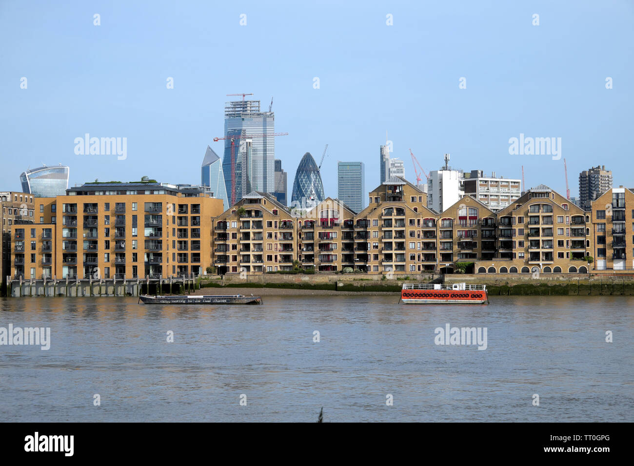 River Thames near Wapping riverside apartments with a cityscape skyline  view of the City of London skyscrapers London England UK    KATHY DEWITT Stock Photo