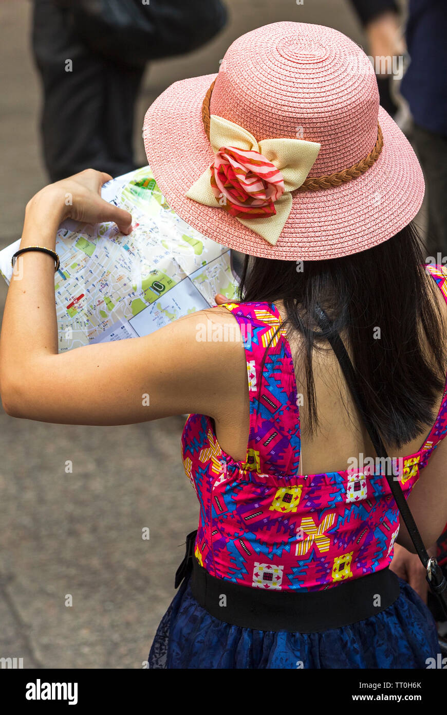 Tourist using a map in the street, Hong Kong, SAR, China Stock Photo