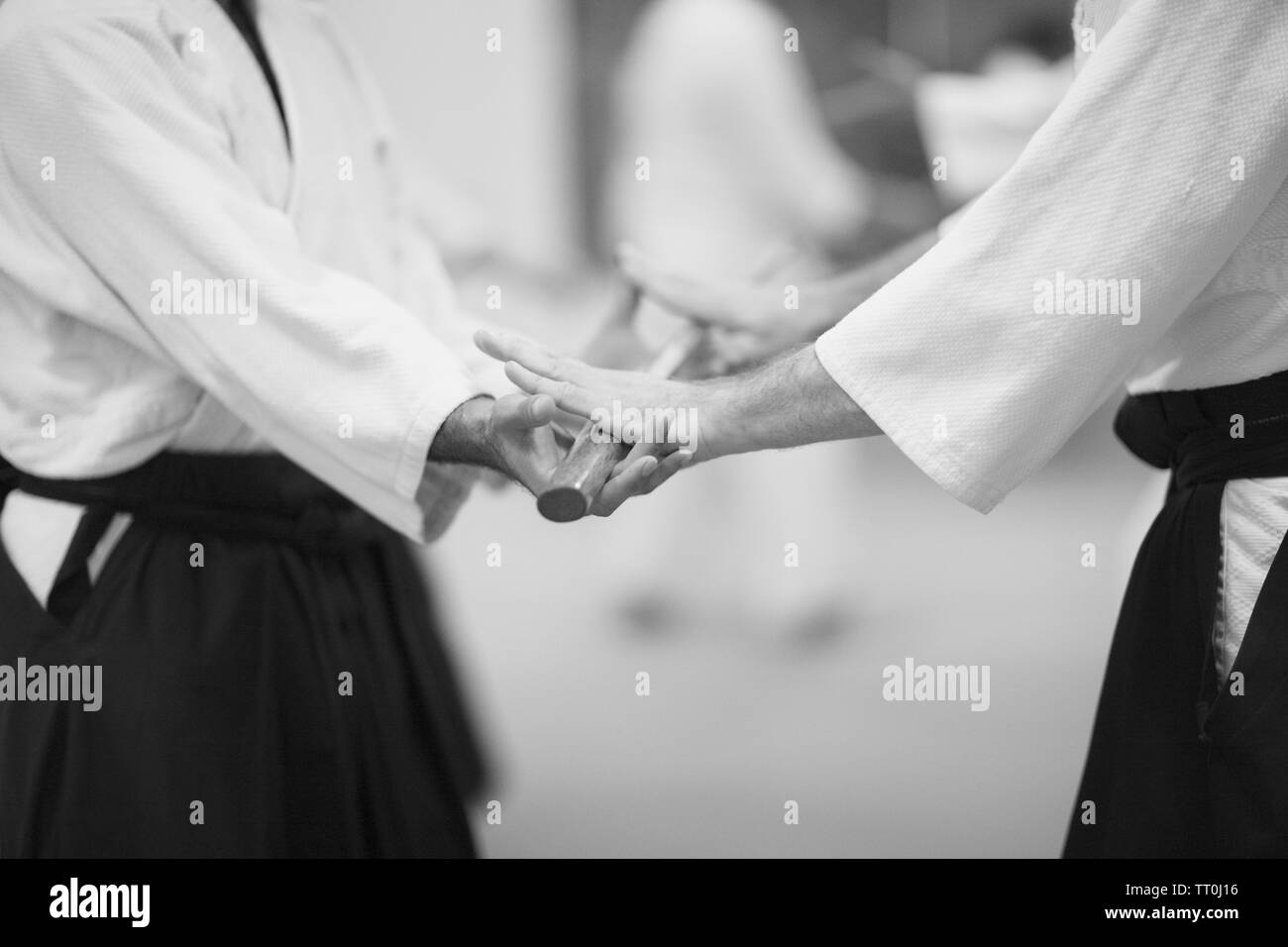 Touching the sword fighting partners. Rituals of aikido Stock Photo