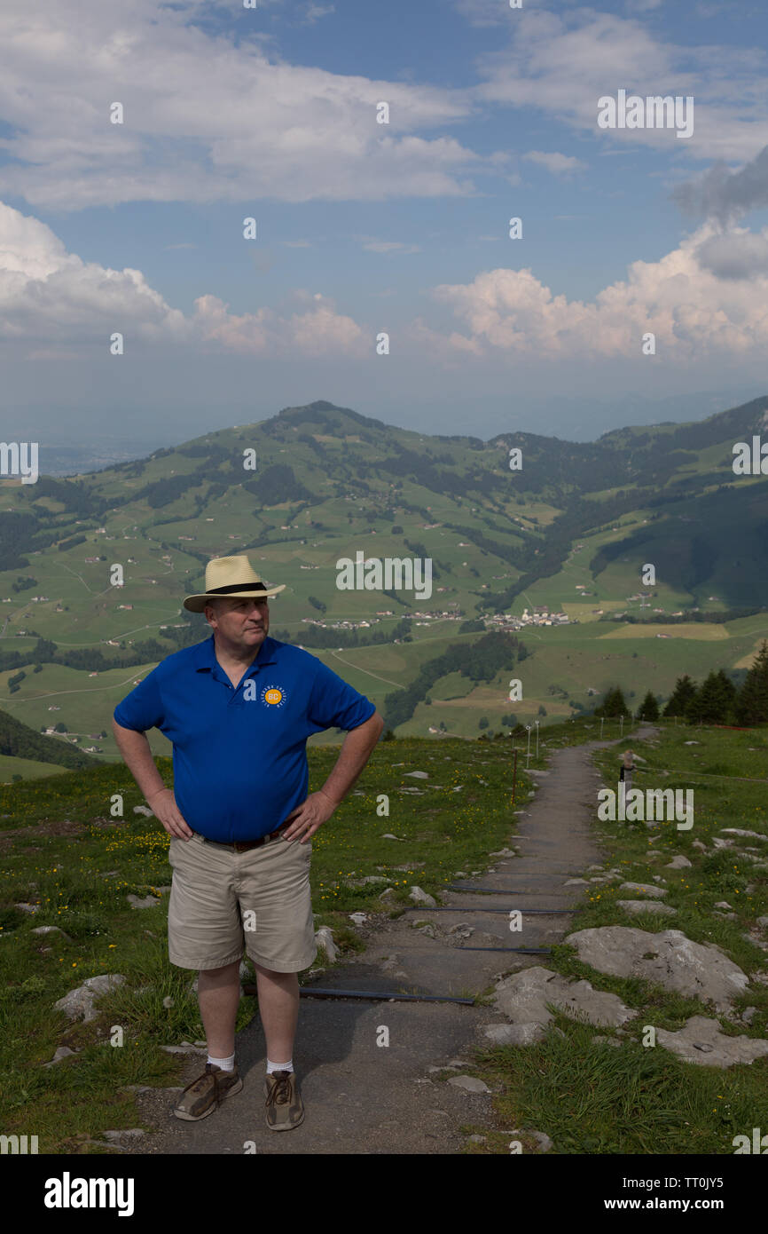 An American tourist in the Appenzell Alps of Switzerland. Stock Photo