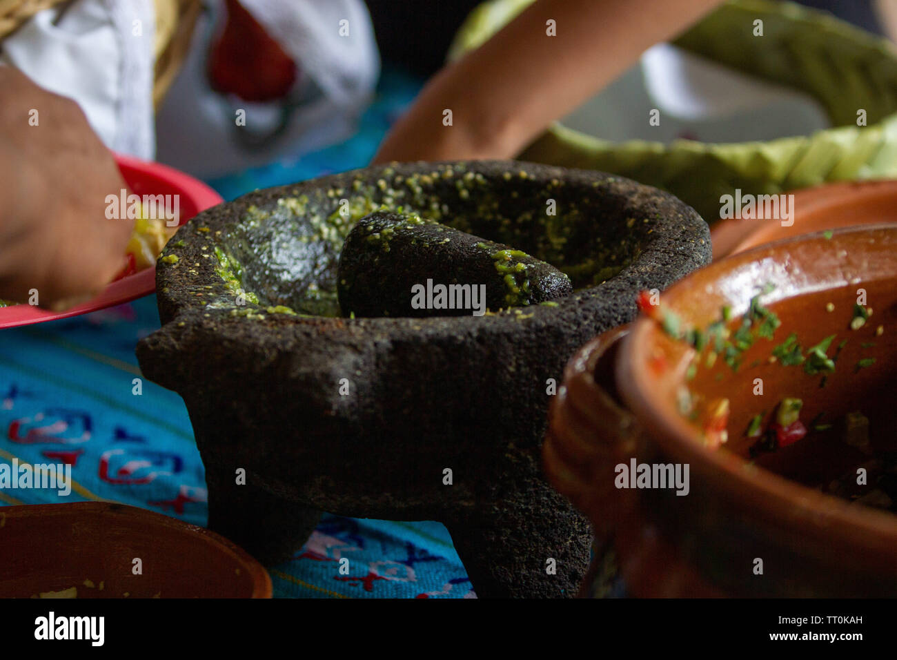 close up of a molcajete with green hot mexican salsa Stock Photo