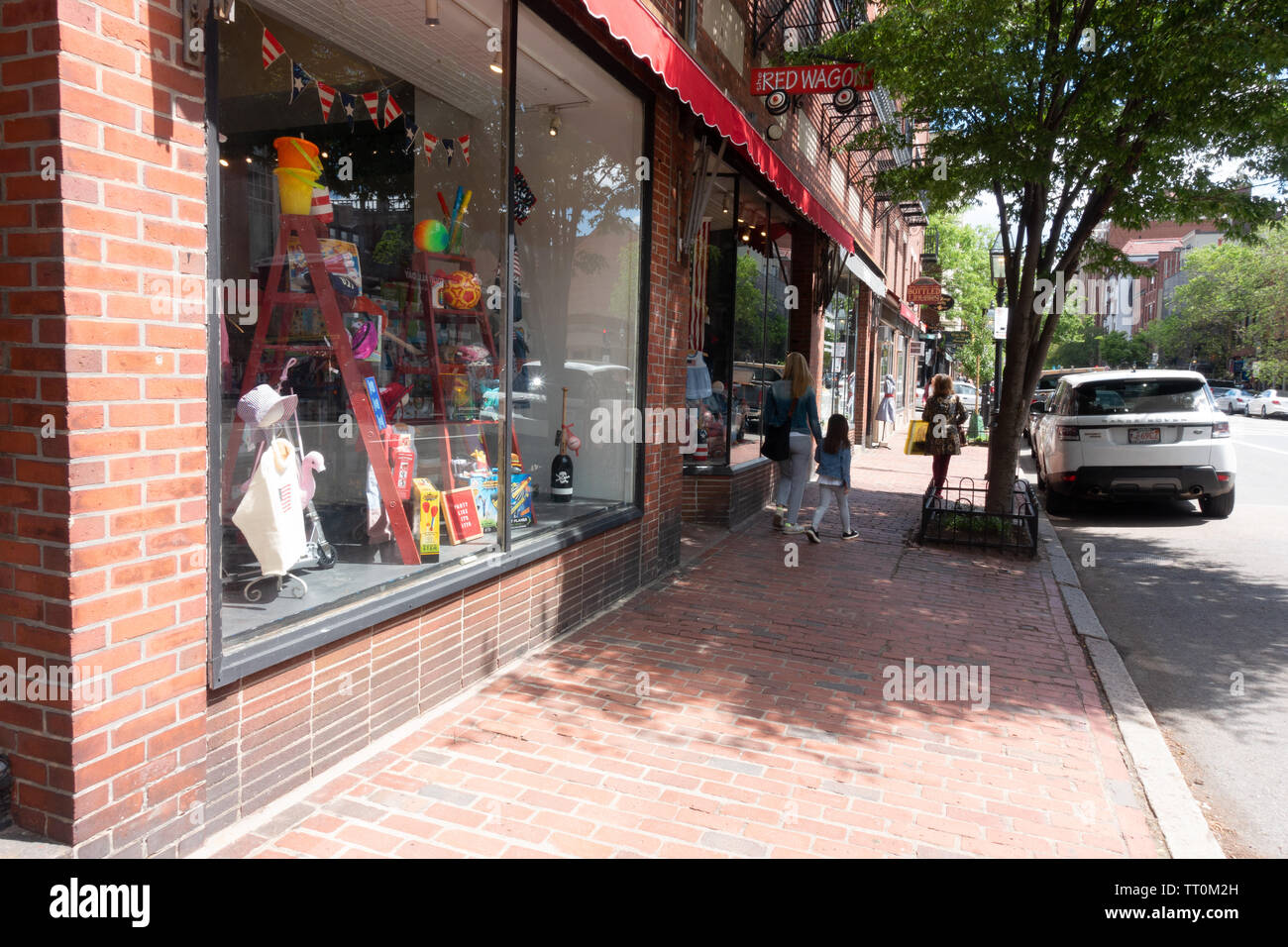 Brick storefronts and sidewalks on Charles Street in Beacon Hill, Boston Massachusetts Stock Photo