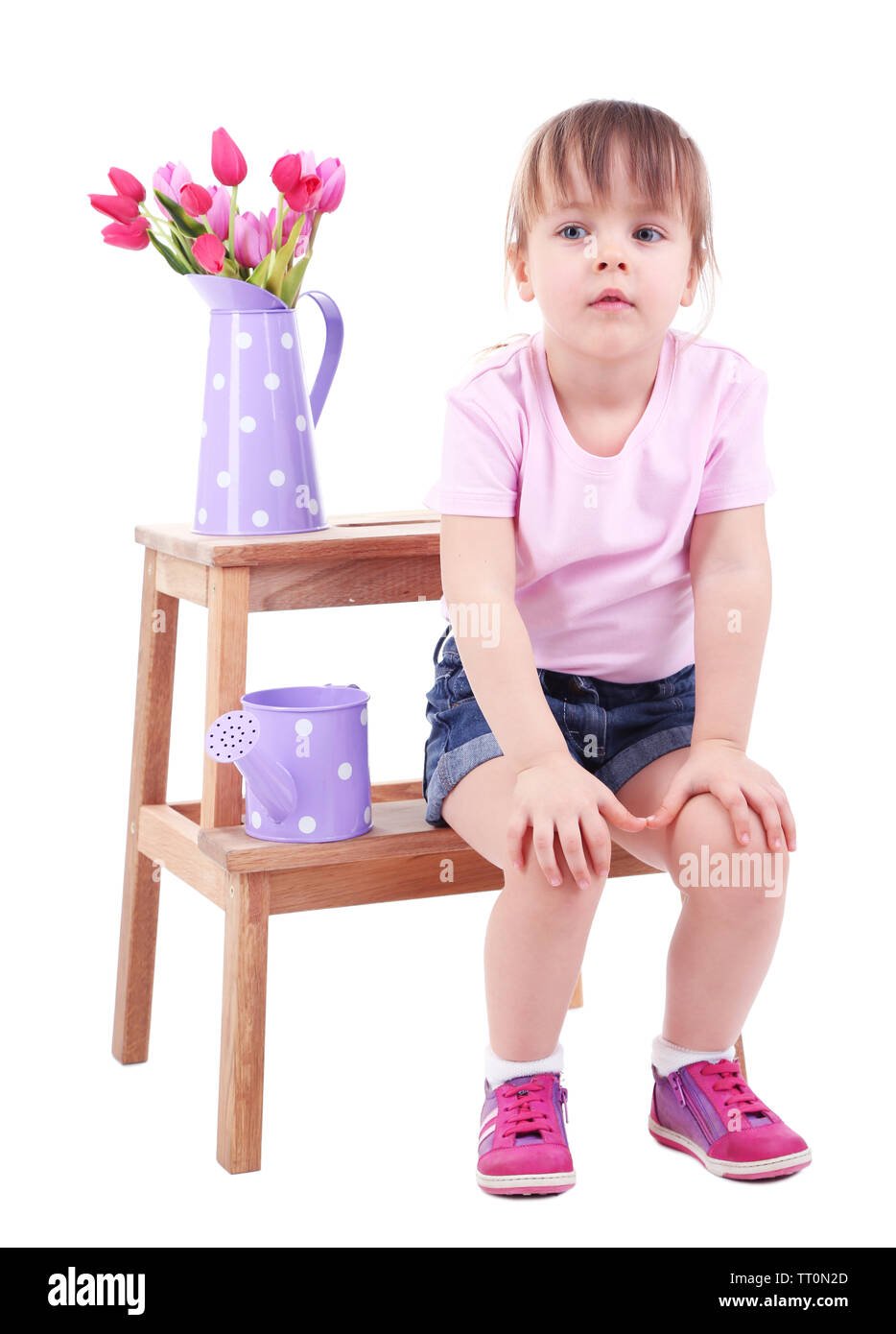Beautiful little girl sitting on small ladder isolated on white Stock Photo