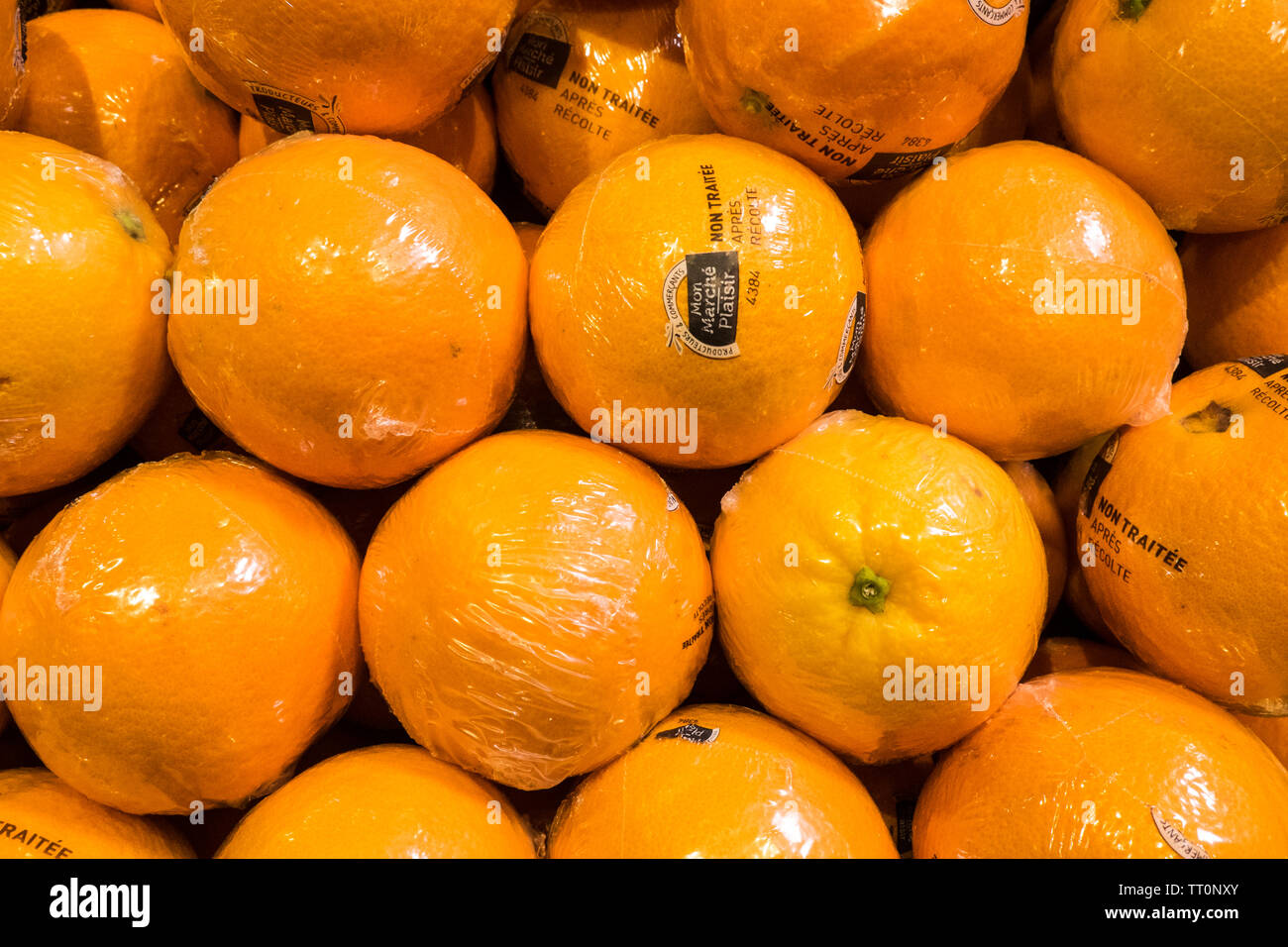 Individual,individually,plastic,wrapped,oranges,shipped,from,Portugal,and,for,sale,in,supermarket,Aude,province,south,of,France,French,Europe,European Stock Photo