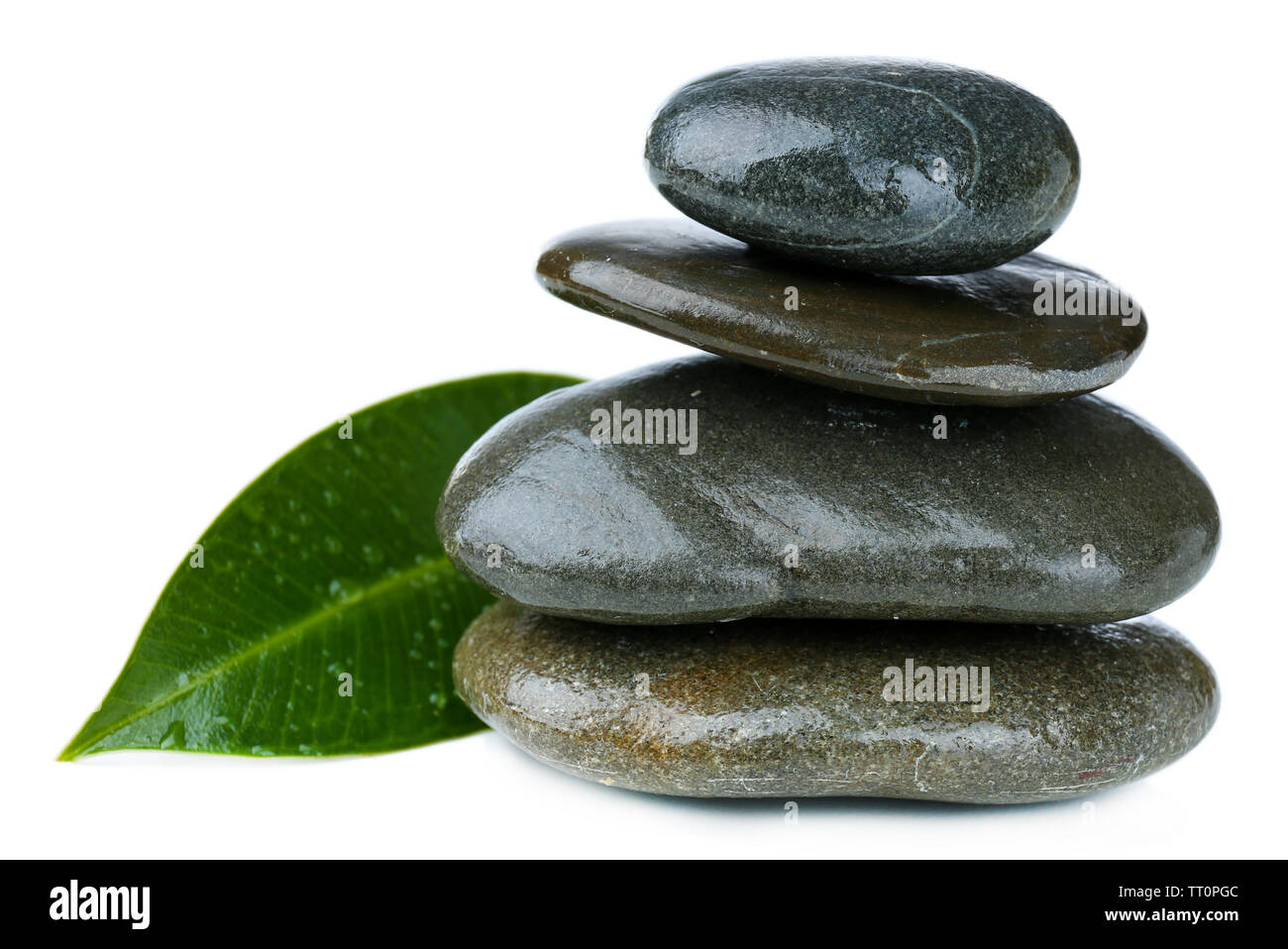 Spa stones with green leaf, isolated on white Stock Photo - Alamy