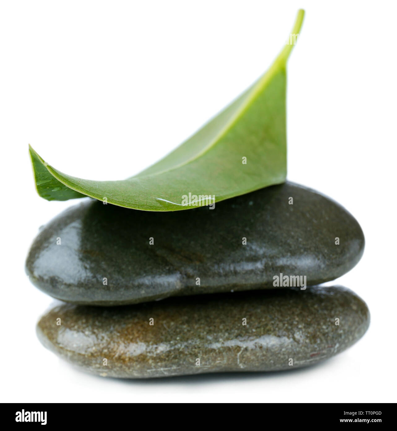 Spa stones with green leaf, isolated on white Stock Photo - Alamy