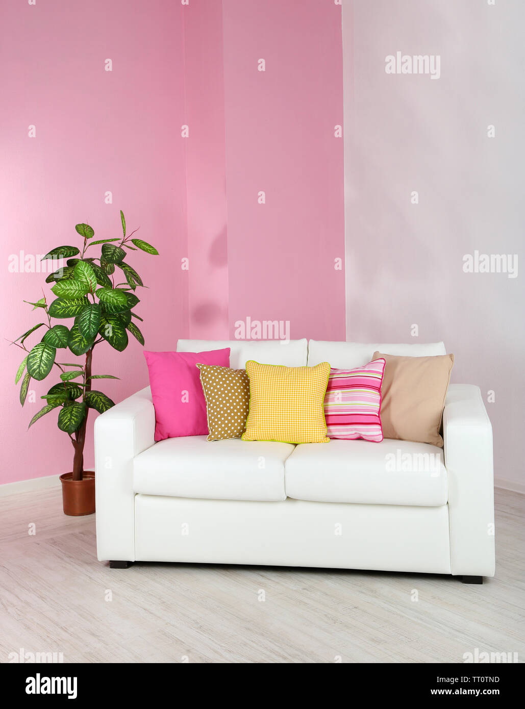 White sofa in room on pink wall background Stock Photo